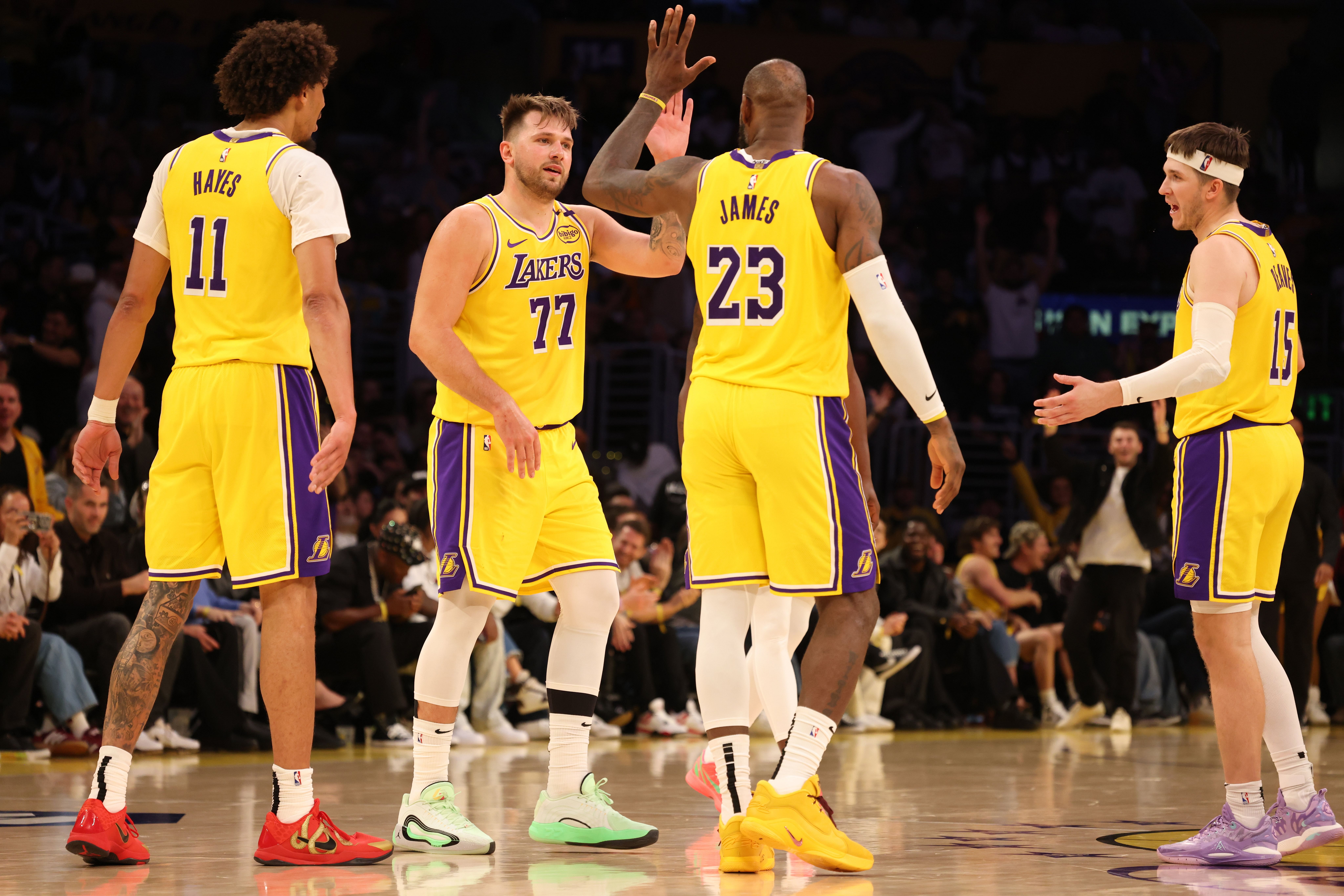 Luka Doncic (77) celebrates with forward LeBron James (23) after making a basket during the fourth quarter against the Minnesota Timberwolves at Crypto.com Arena. (Imagn)