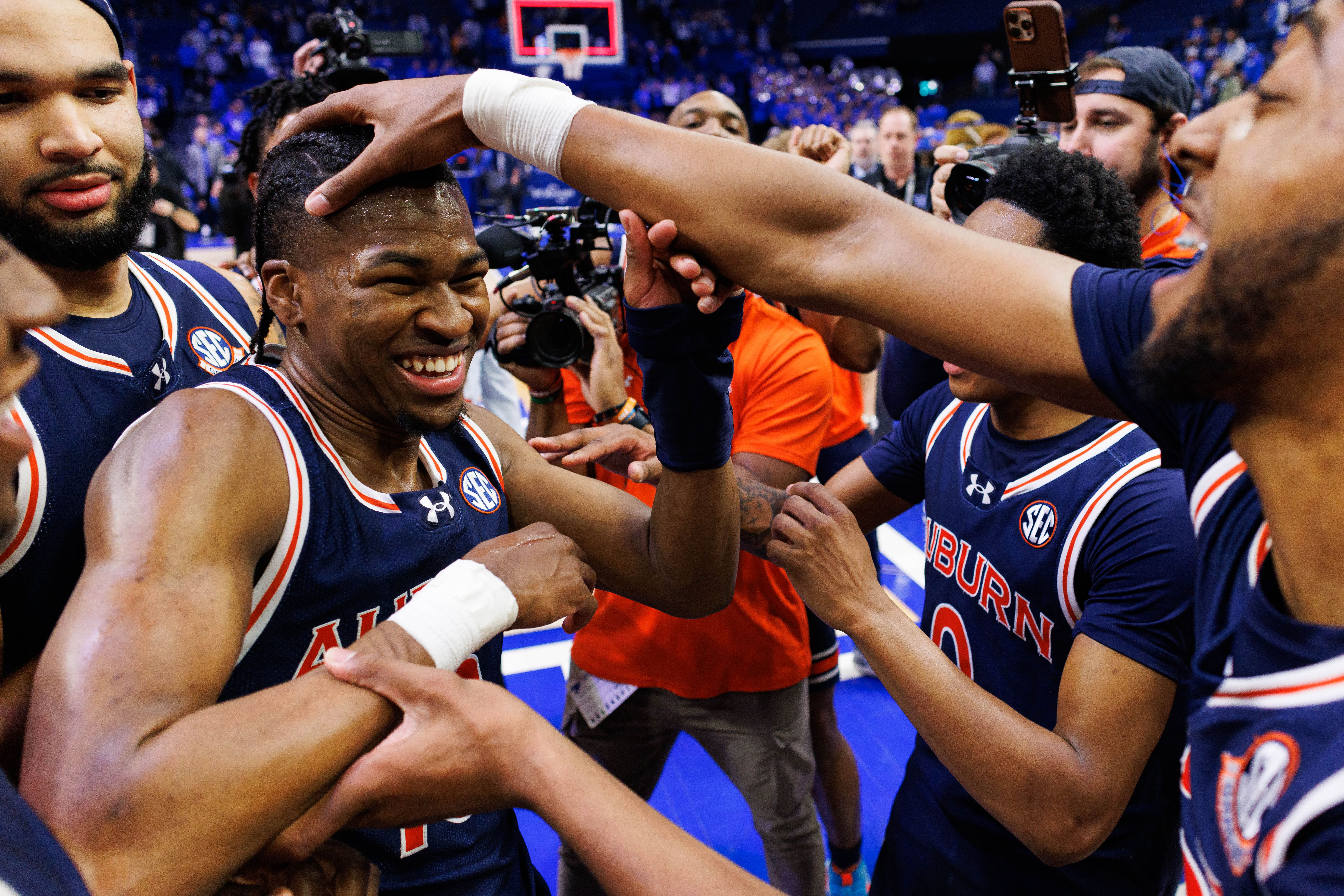 Auburn Tigers forward Chaney Johnson celebrates with guard Miles Kelly after the game against the Kentucky Wildcats at Rupp Arena. Photo: Imagn