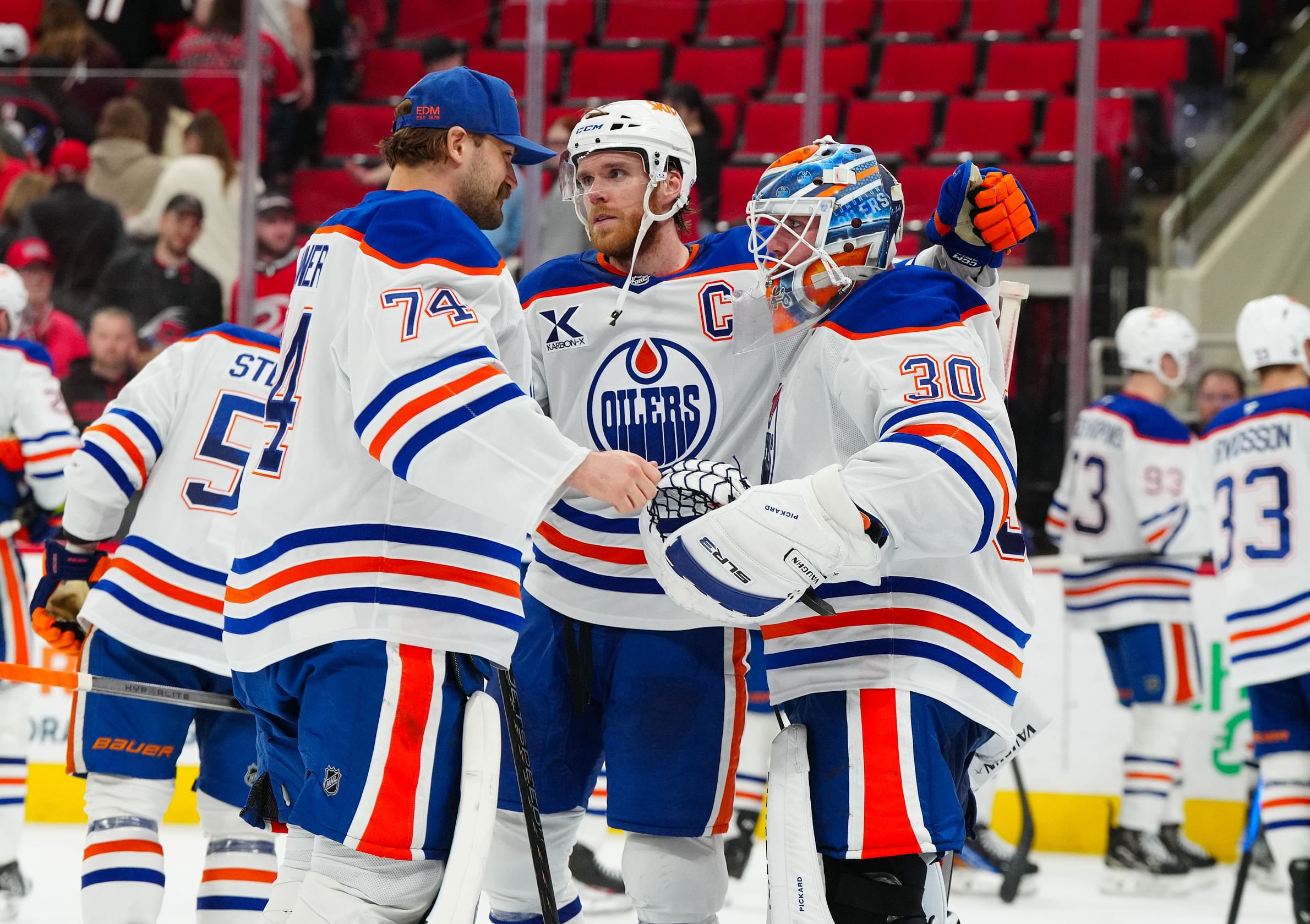 Mar 1, 2025; Raleigh, North Carolina, USA; Edmonton Oilers goaltender Calvin Pickard (30) celebrate their victory with center Connor McDavid (97) and goaltender Stuart Skinner (74) against the Carolina Hurricanes at Lenovo Center. Mandatory Credit: James Guillory-Imagn Images - Source: Imagn