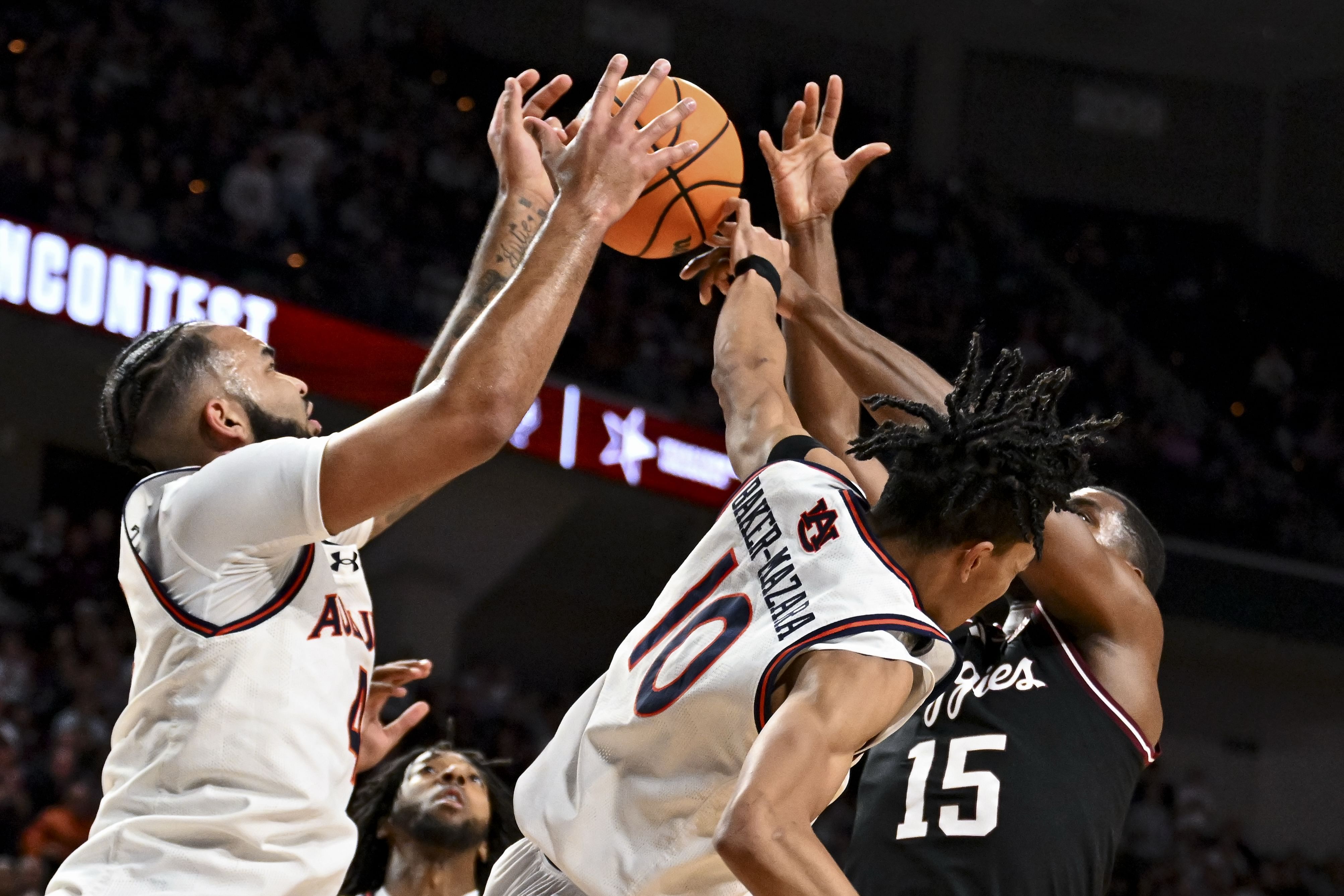 Texas A&amp;M Aggies forward Henry Coleman III (15) attempts to shoot the ball as Auburn Tigers forward Johni Broome (4) and guard Chad Baker-Mazara (10) defend during the first half at Reed Arena. Photo: Imagn