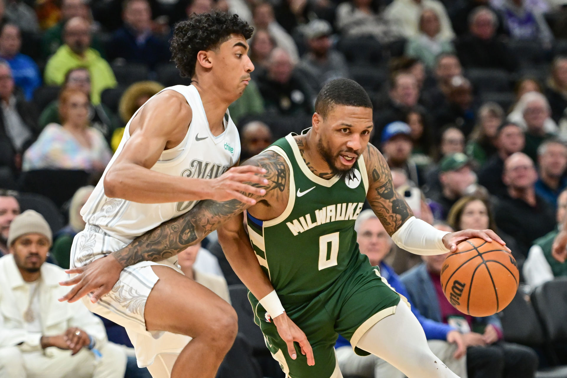 Milwaukee Bucks guard Damian Lillard drives to the basket against Dallas Mavericks guard Max Christie at Fiserv Forum. Photo Credit: Imagn