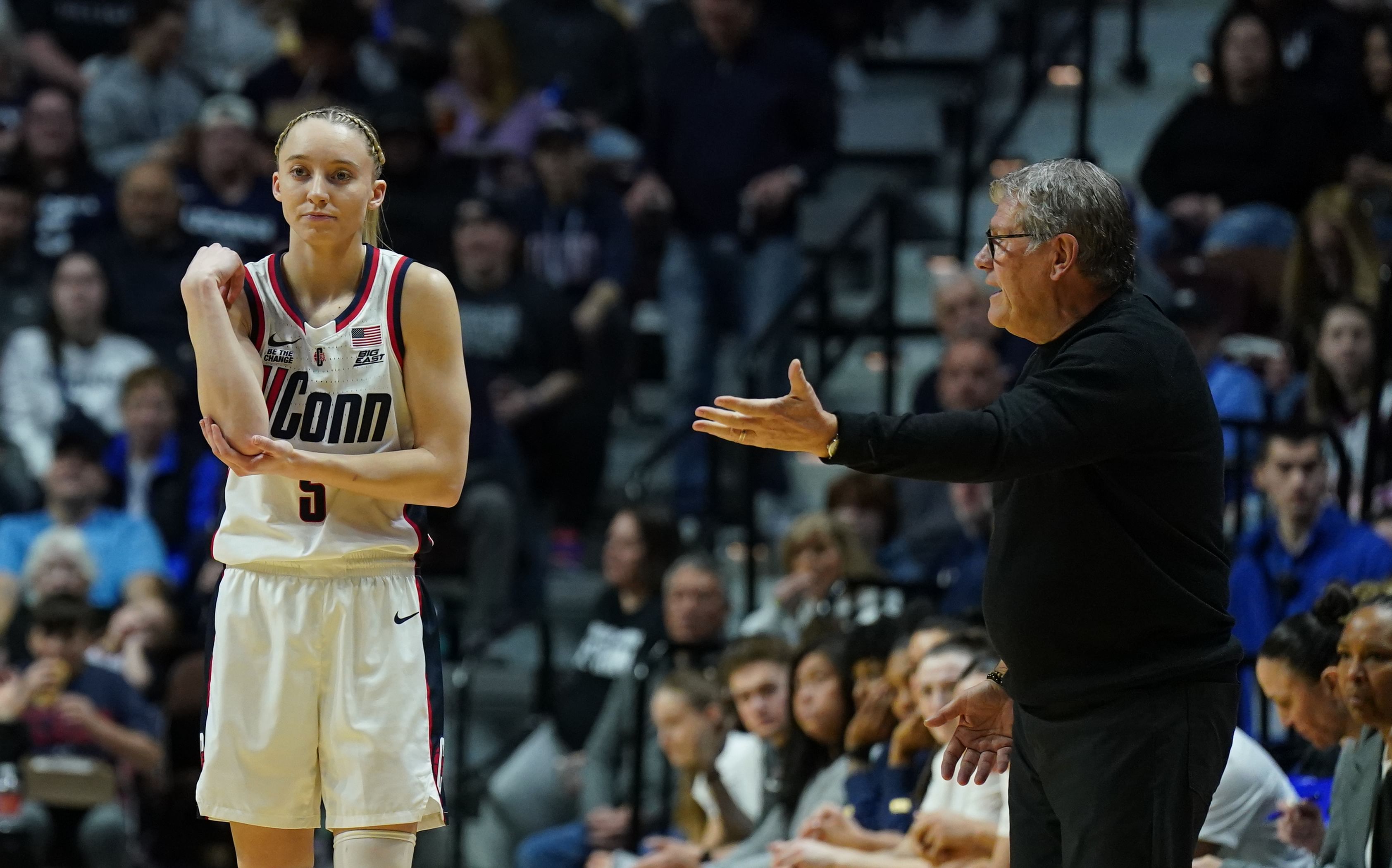 UConn Huskies head coach Geno Auriemma talks to guard Paige Bueckers (5) from the sideline as they take on the St. John&#039;s Red Storm at Mohegan Sun Arena. Photo: Imagn