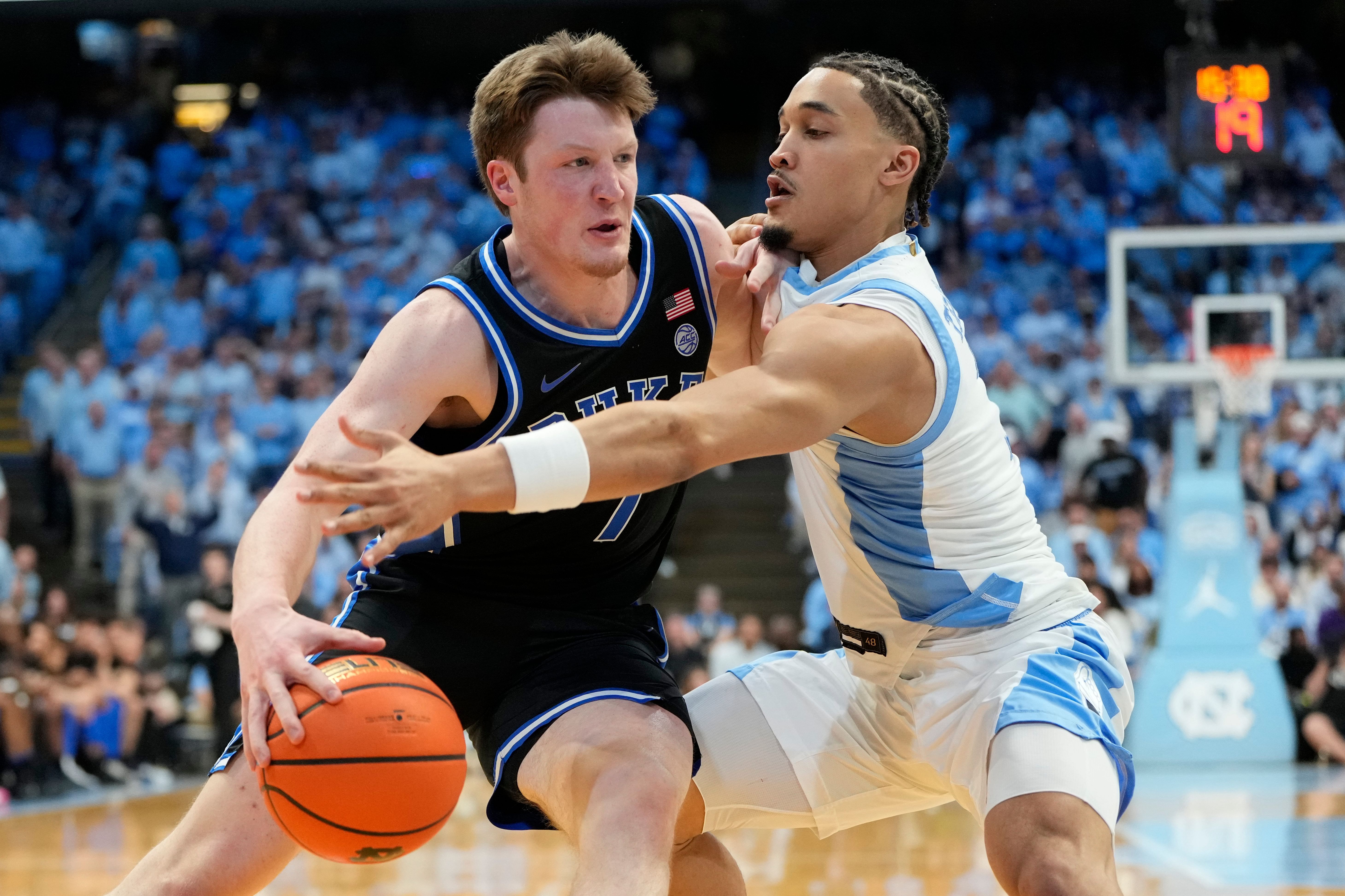 Duke Blue Devils guard Kon Knueppel (#7) with the ball as North Carolina Tar Heels guard Seth Trimble (#7) defends in the first half at Dean E. Smith Center. Photo: Imagn