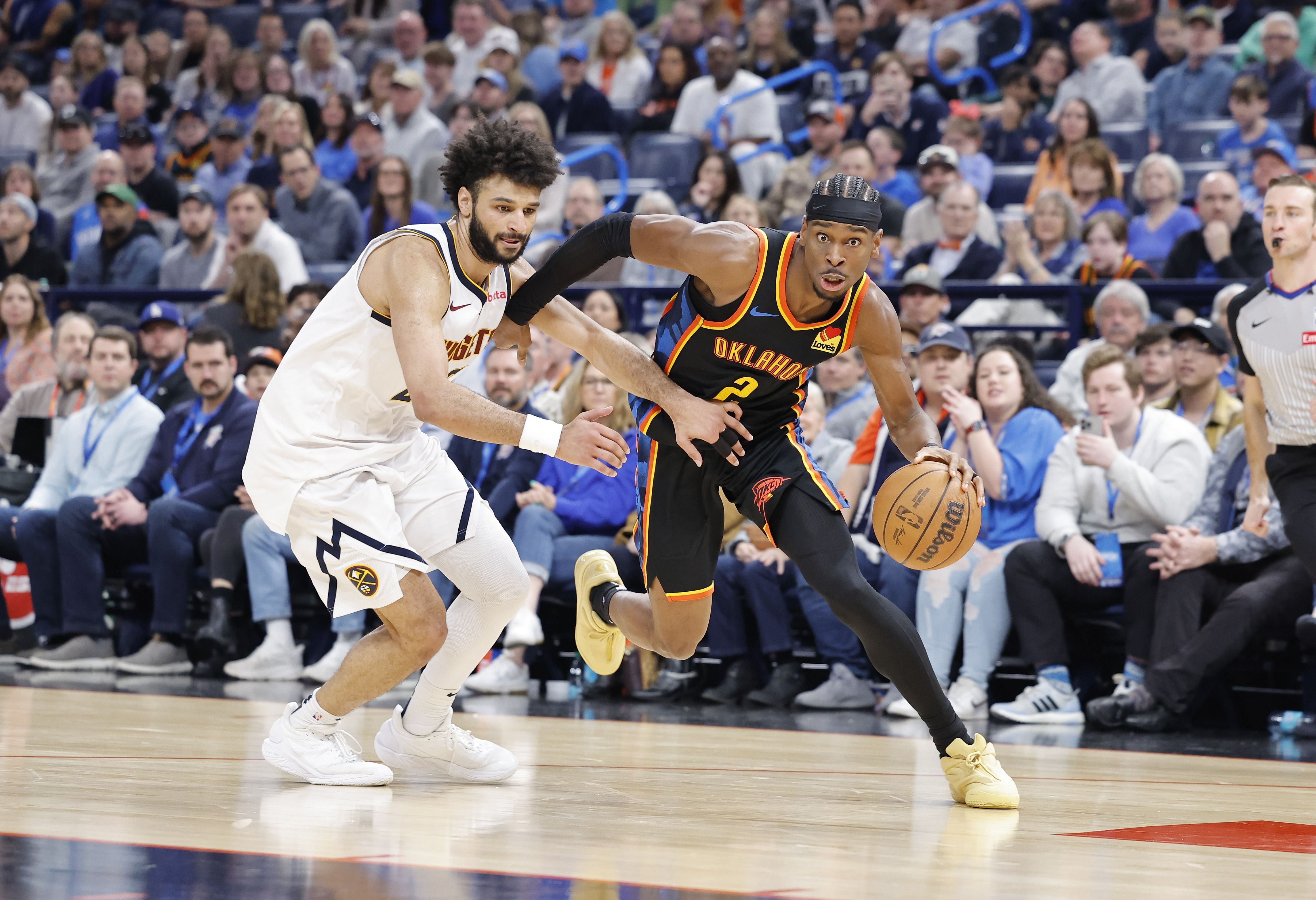 Oklahoma City Thunder guard Shai Gilgeous-Alexander drives around Denver Nuggets guard Jamal Murray at Paycom Center. Photo Credit: Imagn