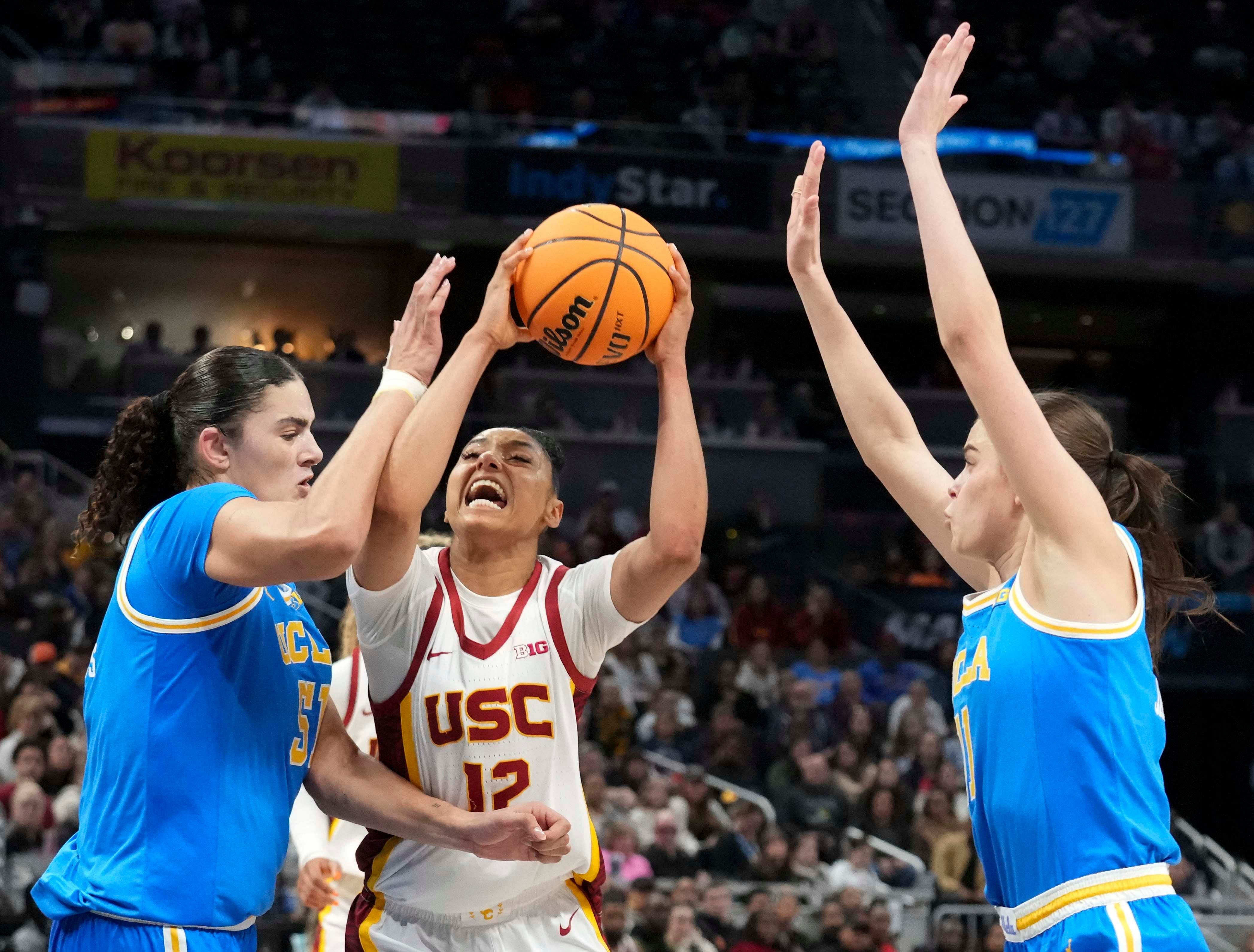 UCLA Bruins guard Gabriela Jaquez (11) and center Lauren Betts (51) defend USC Trojans guard JuJu Watkins (12) in the second half of the 2025 Big Ten Tournament finals on March 9, 2025, at Gainbridge Fieldhouse. Photo: Imagn