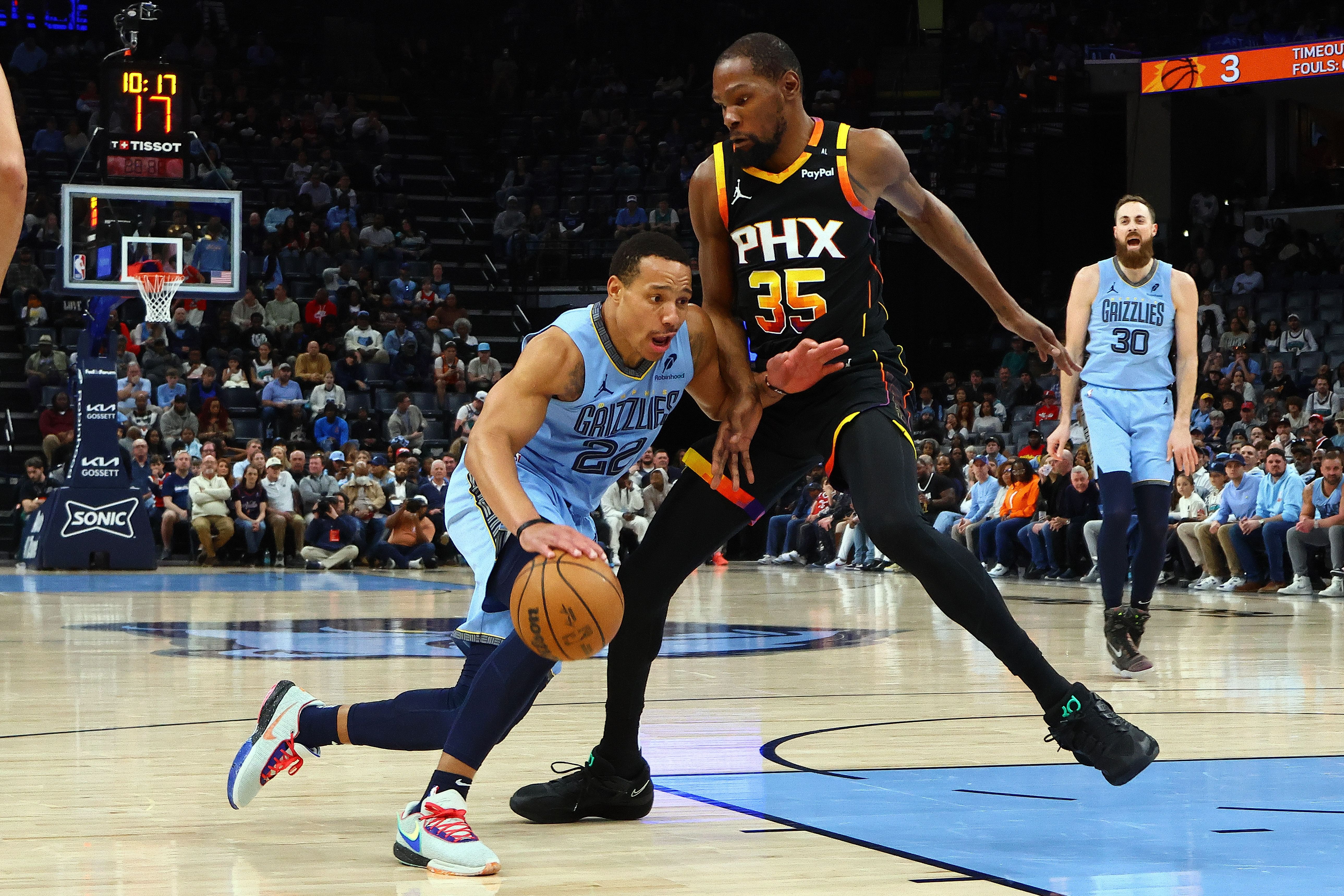 Mar 10, 2025; Memphis, Tennessee, USA; Memphis Grizzlies guard Desmond Bane (22) drives to the basket as Phoenix Suns forward Kevin Durant (35) defends during the first quarter at FedExForum. Mandatory Credit: Petre Thomas-Imagn Images - Source: Imagn