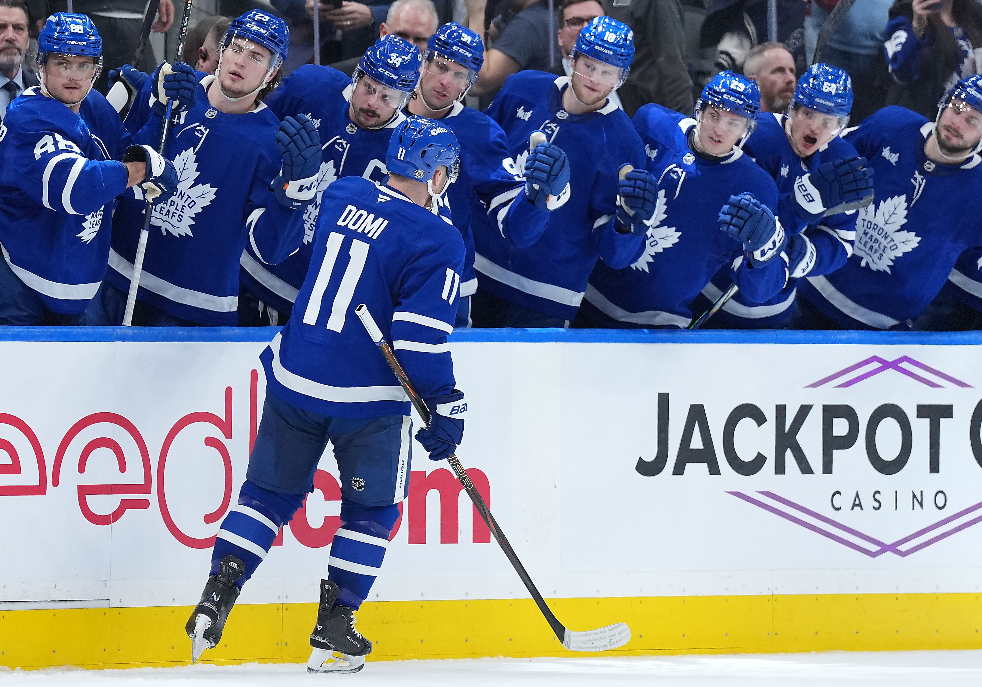 Mar 13, 2025; Toronto, Ontario, CAN; Toronto Maple Leafs center Max Domi (11) celebrates at the bench after scoring a goal against the Florida Panthers during the third period at Scotiabank Arena. Mandatory Credit: Nick Turchiaro-Imagn Images - Source: Imagn