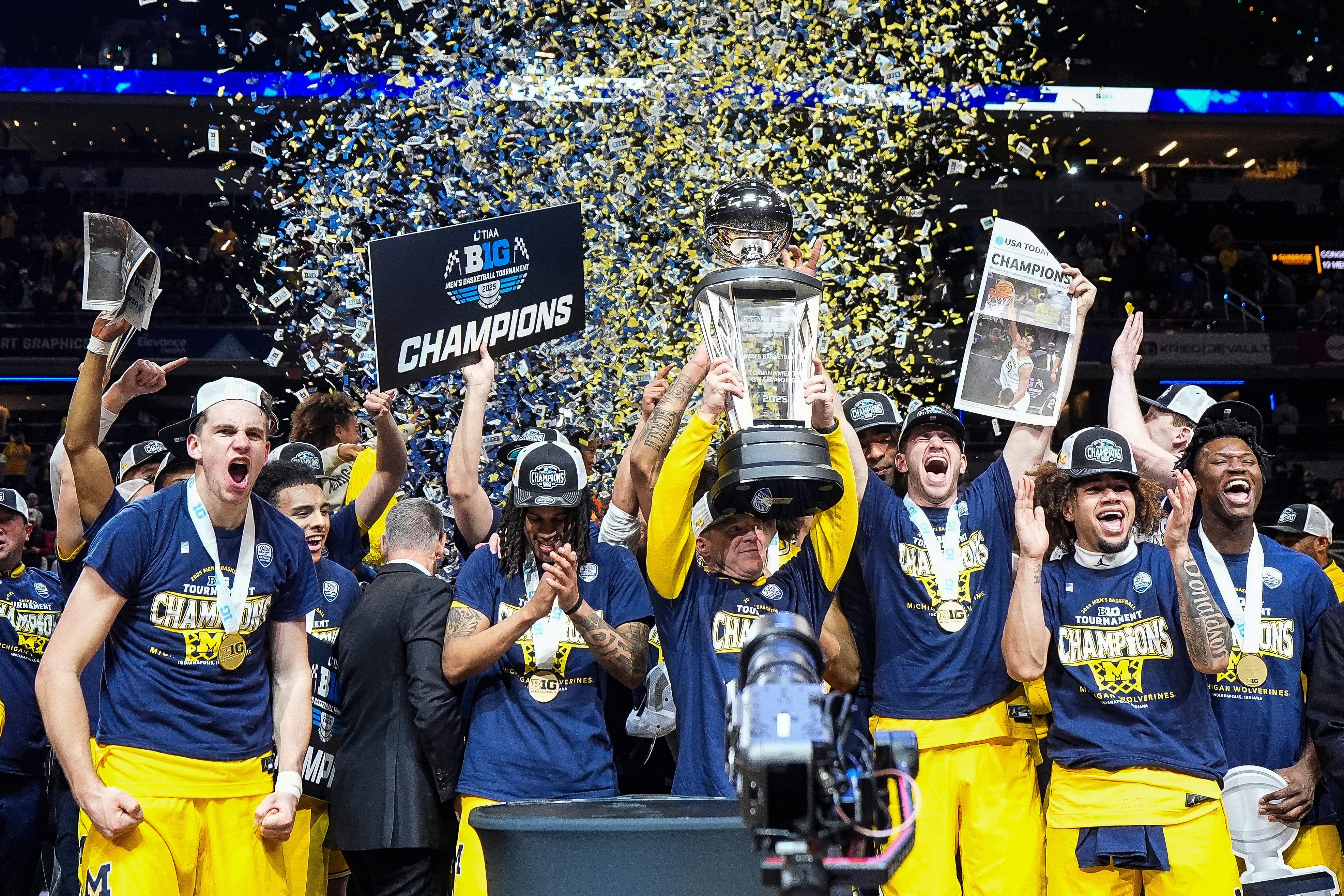 Head coach Dusty May, center right, lifts the trophy to celebrate the Wolverines&#039; 59-53 win over the Wisconsin Badgers at the Big Ten Tournament championship game at Gainbridge Fieldhouse in Indianapolis, Indiana on March 16, 2025. Photo: Imagn