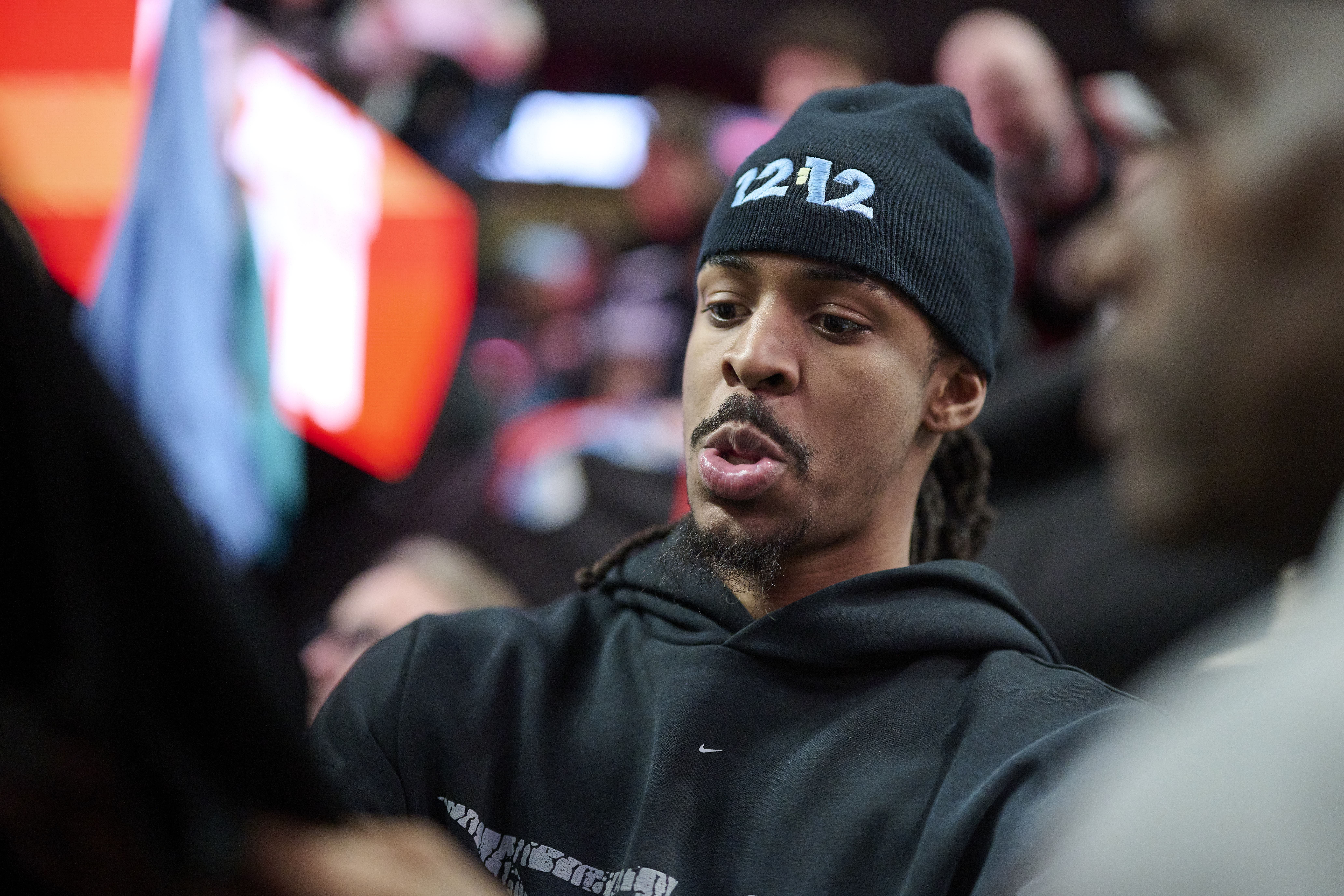 Mar 19, 2025; Portland, Oregon, USA; Memphis Grizzlies guard Ja Morant (12) signs autographs for fans after a game against the Portland Trail Blazers at Moda Center. Mandatory Credit: Troy Wayrynen-Imagn Images - Source: Imagn