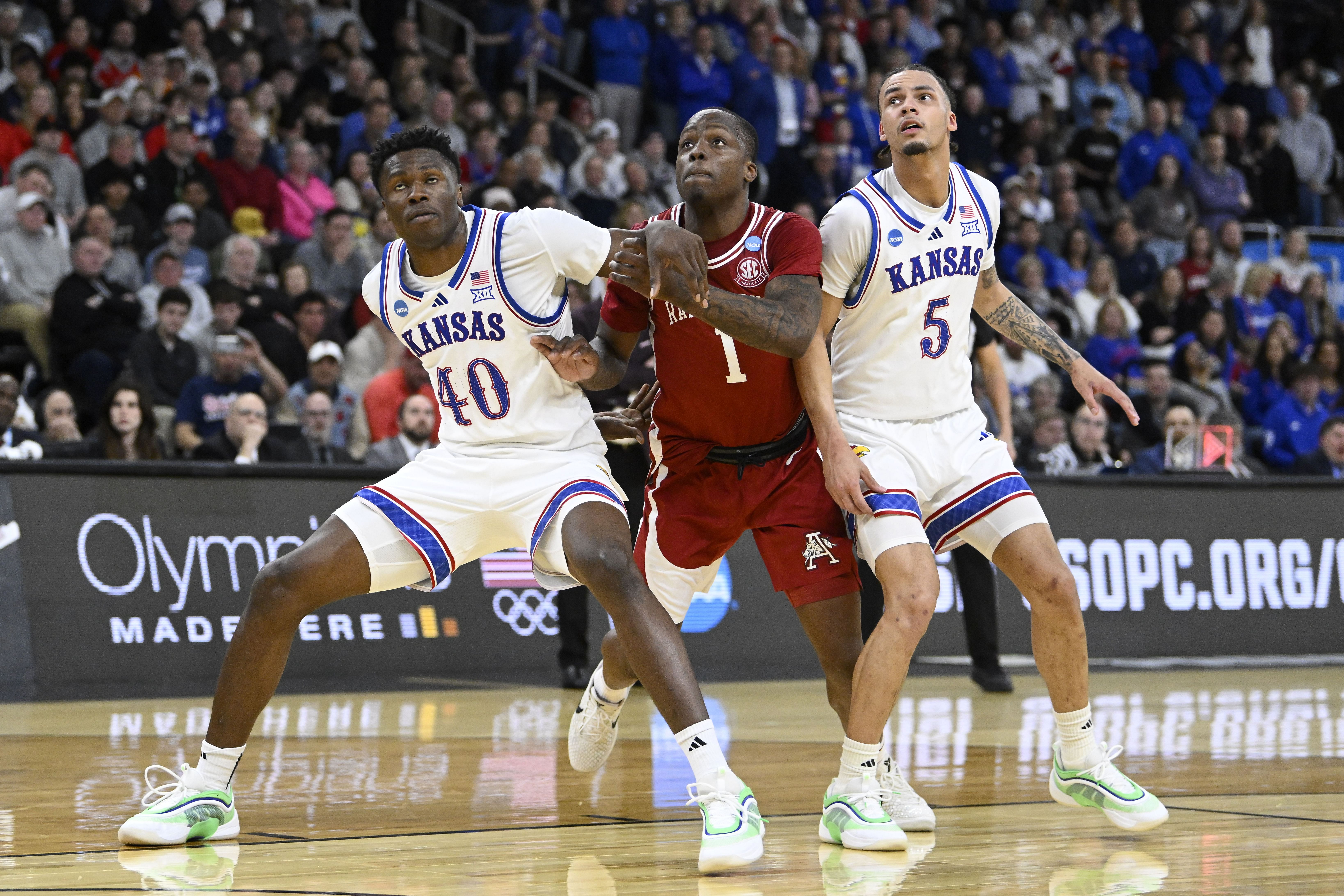 Arkansas Razorbacks guard Johnell Davis (#1) and Kansas Jayhawks forward Flory Bidunga (#40) and guard Zeke Mayo (#5) look on during the second half at Amica Mutual Pavilion. Photo: Imagn