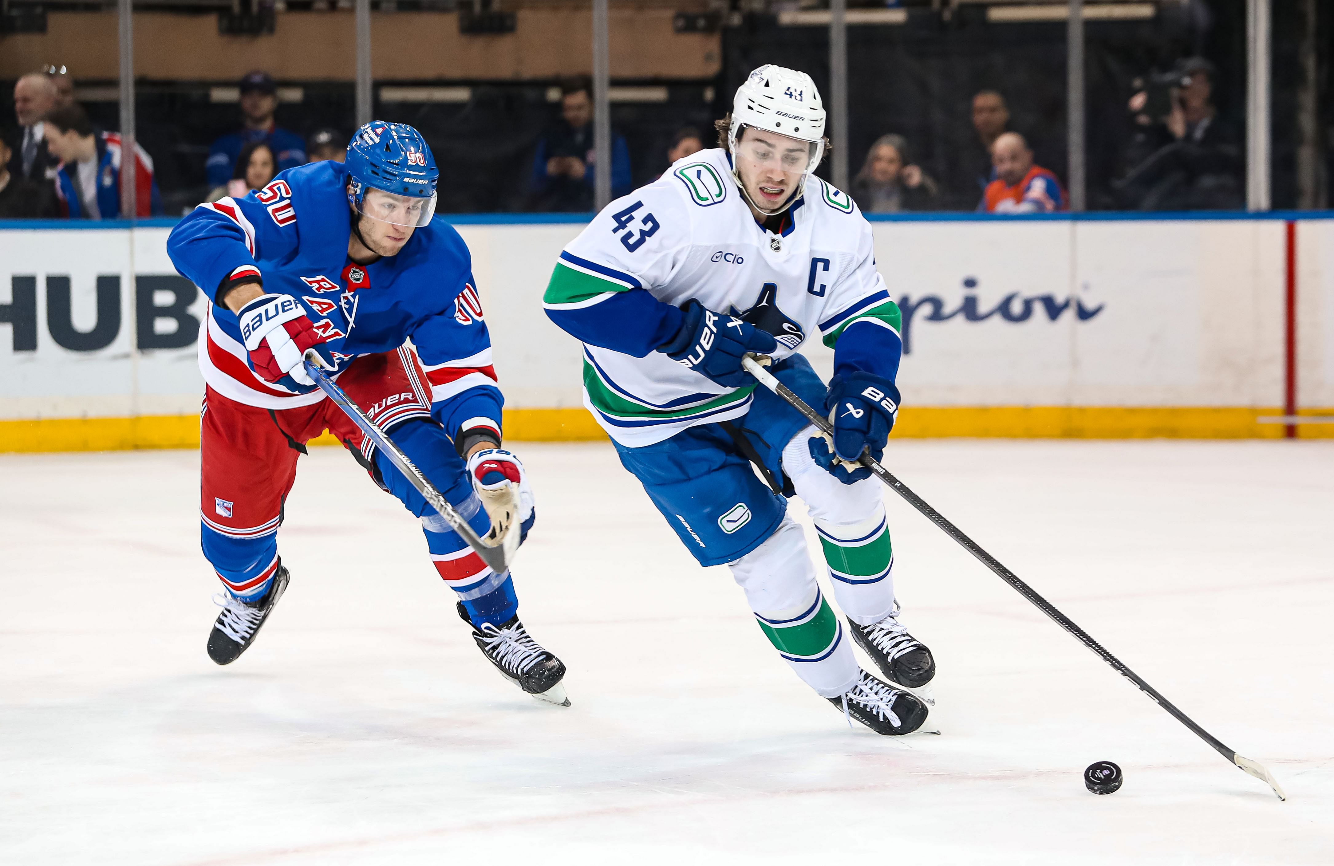 Mar 22, 2025; New York, New York, USA; New York Rangers left wing Will Cuylle (50) chases Vancouver Canucks defenseman Quinn Hughes (43) during the third period at Madison Square Garden. Mandatory Credit: Danny Wild-Imagn Images - Source: Imagn