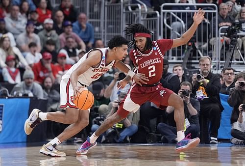 St. John's Red Storm guard RJ Luis Jr. (#12) dribbles against Arkansas Razorbacks guard Boogie Fland (#2) during the second half of their second-round game in the 2025 NCAA Tournament at Amica Mutual Pavilion. Photo: Imagn
