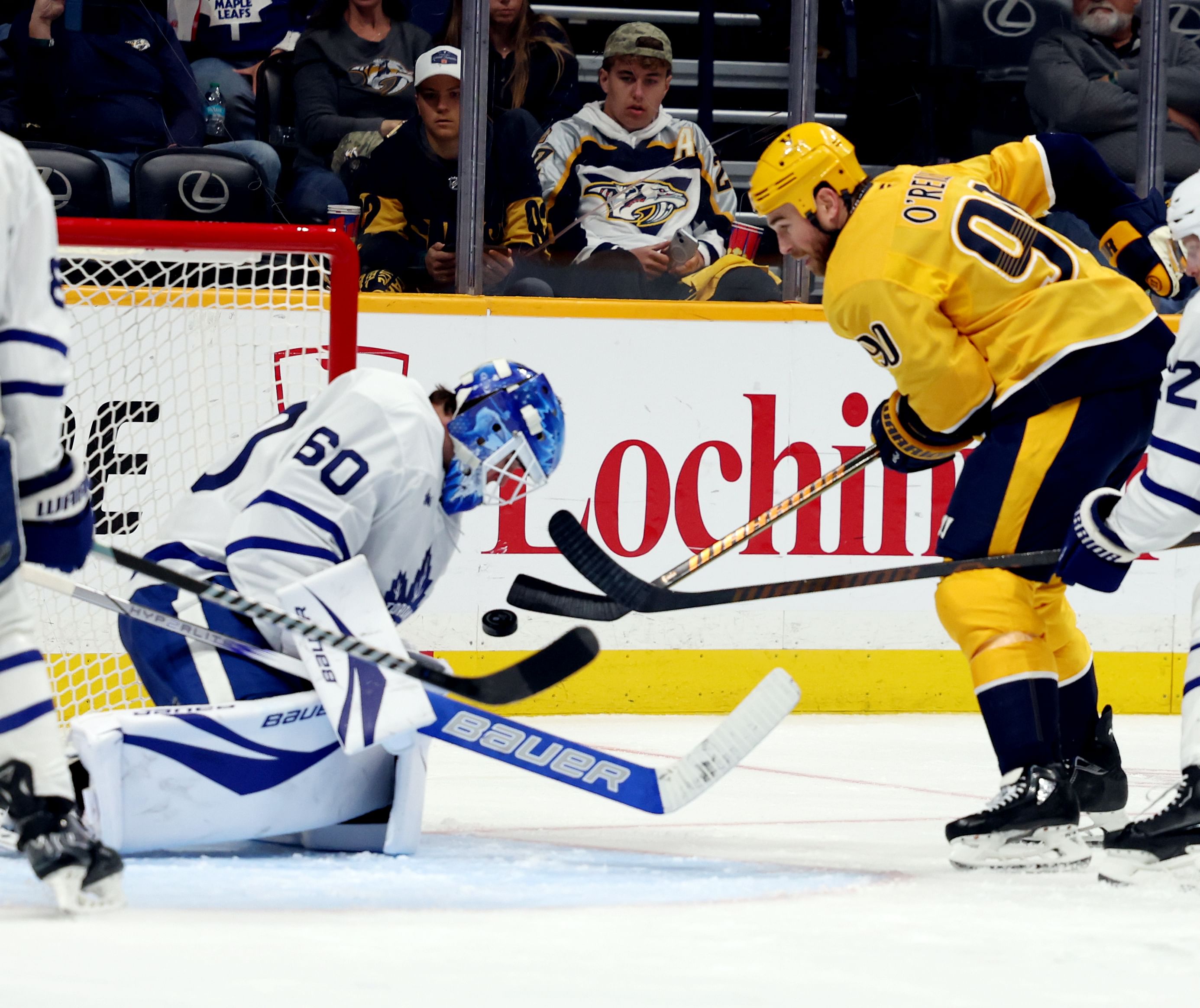 Mar 22, 2025; Nashville, Tennessee, USA; Toronto Maple Leafs goalie Joseph Woll (60) stops a shot by Nashville Predators center Ryan O