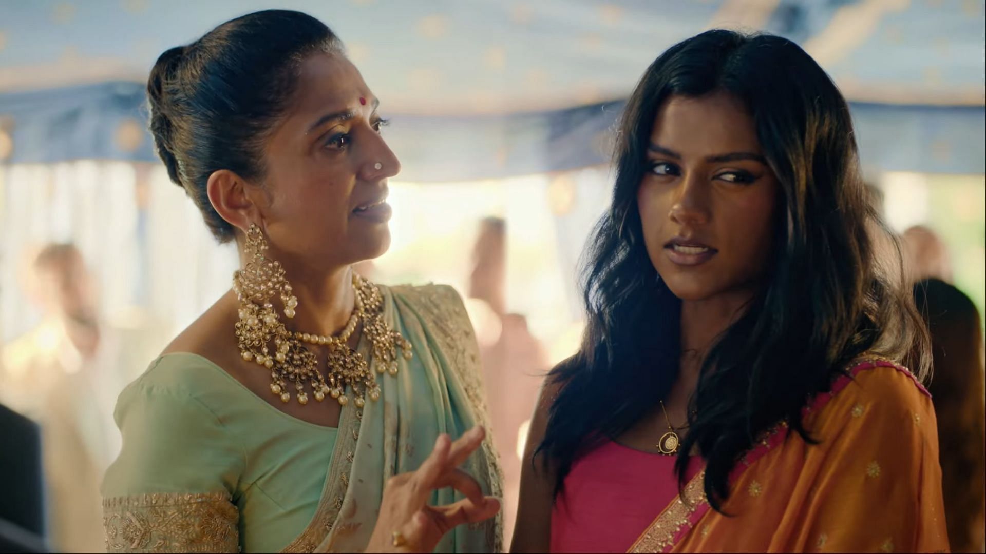  A still from Picture This (2025) featuring Simone Ashley as Pia and Sindhu Vee as Laxmi, captured in a lively family gathering.  (Image via Amazon Prime/Youtube)