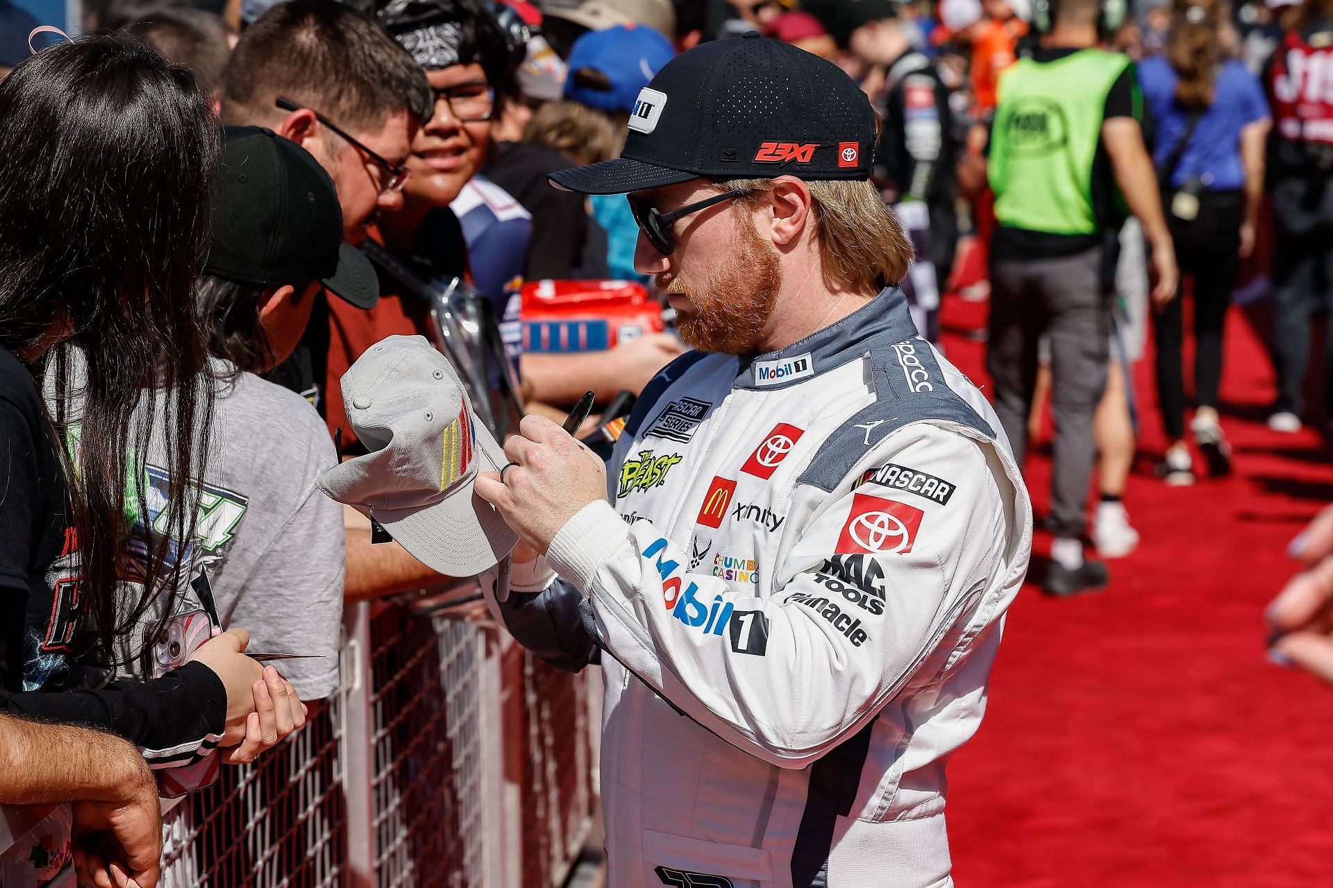 Tyler Reddick signs an autograph before the NASCAR Cup Series Shriners Children&#039;s 500 - Source: Getty