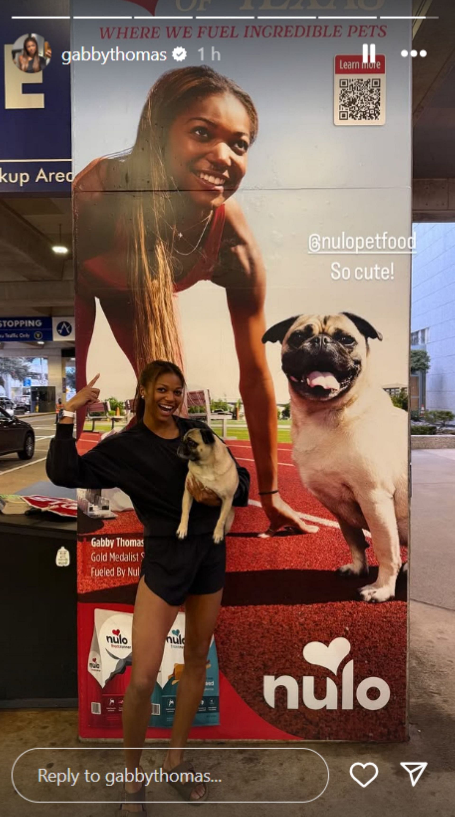 Gabby Thomas and Rico pose in front of the poster; Instagram - @gabbythomas