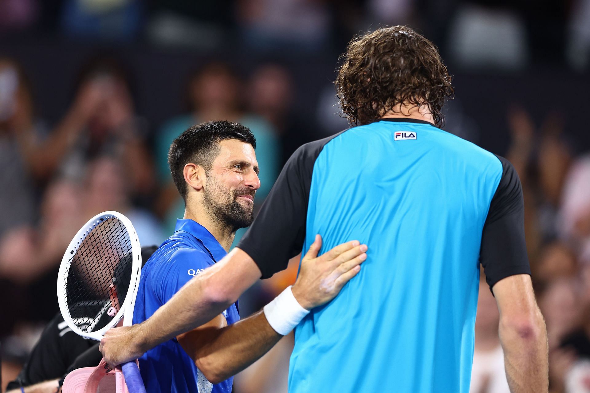 Novak Djokovic of Serbia and Reilly Opelka of the USA after their quarter-final match during day six of the 2025 Brisbane International - Source: Getty