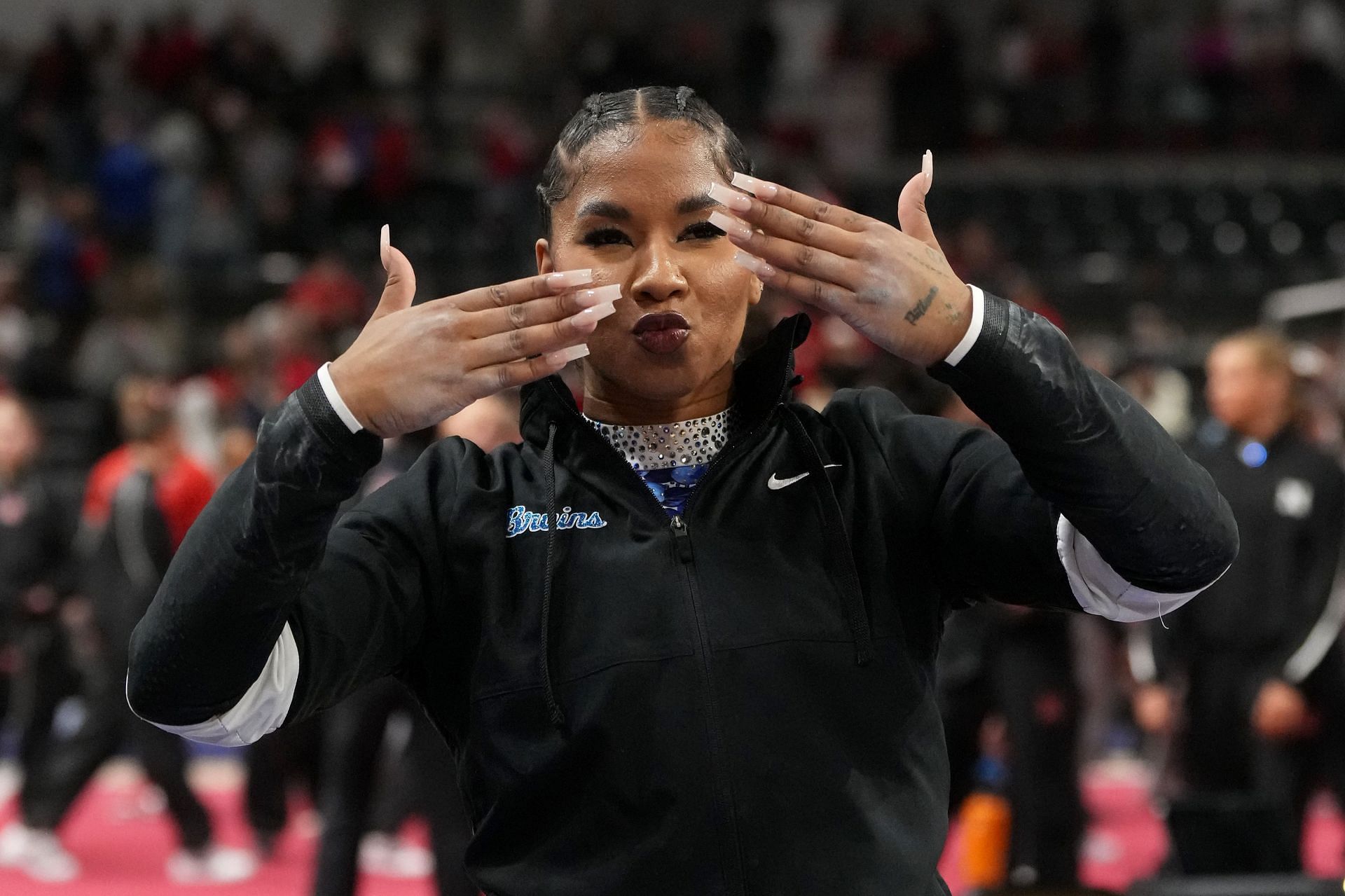 Jordan Chiles waving to the crowd at the Big Ten Regular Season 2025&#039; Big Fours [Image Source: Getty]