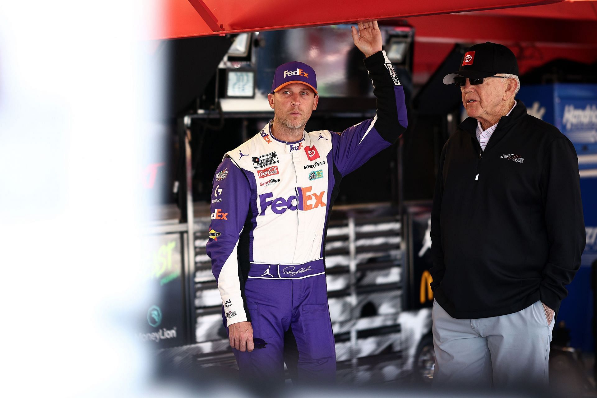 MARTINSVILLE, VIRGINIA - NOVEMBER 02: Denny Hamlin, driver of the #11 FedEx One Rate Toyota, and JGR team owner and NASCAR Hall of Famer, Joe Gibbs talk in the garage area after an on-track incident during practice for the NASCAR Cup Series Xfinity 500 at Martinsville Speedway on November 02, 2024 in Martinsville, Virginia. (Photo by Jared C. Tilton/Getty Images) - Source: Getty