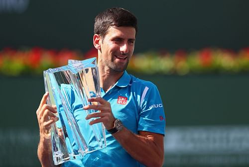 Novak Djokovic of Serbia holds up the winners trophy after his win over Milos Raonic of Canada during day fourteen of the BNP Paribas Open at Indian Wells Tennis Garden on March 20, 2016 - Source: Getty