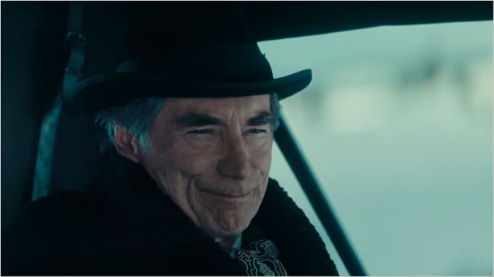 Timothy Dalton as Donald Whitfield smirks as he rides through the snowy landscape, hinting at his next calculated move against the Duttons. (Image via Paramount+)