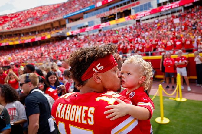 Patrick Mahomes reacts as two-year old son Bronze reels in his catch on fishing trip