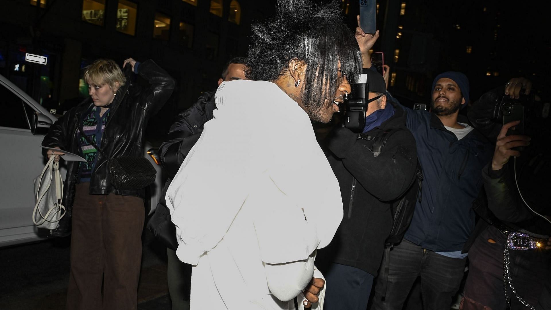 Lil Uzi Vert is seen wearing a Marc Jacobs white and pink hoodie, and white sweatpants with a white and silver studded Marc Jacobs bag outside the Marc Jacobs show on February 03, 2025, in New York City. (Image via Getty/Daniel Zuchnik)