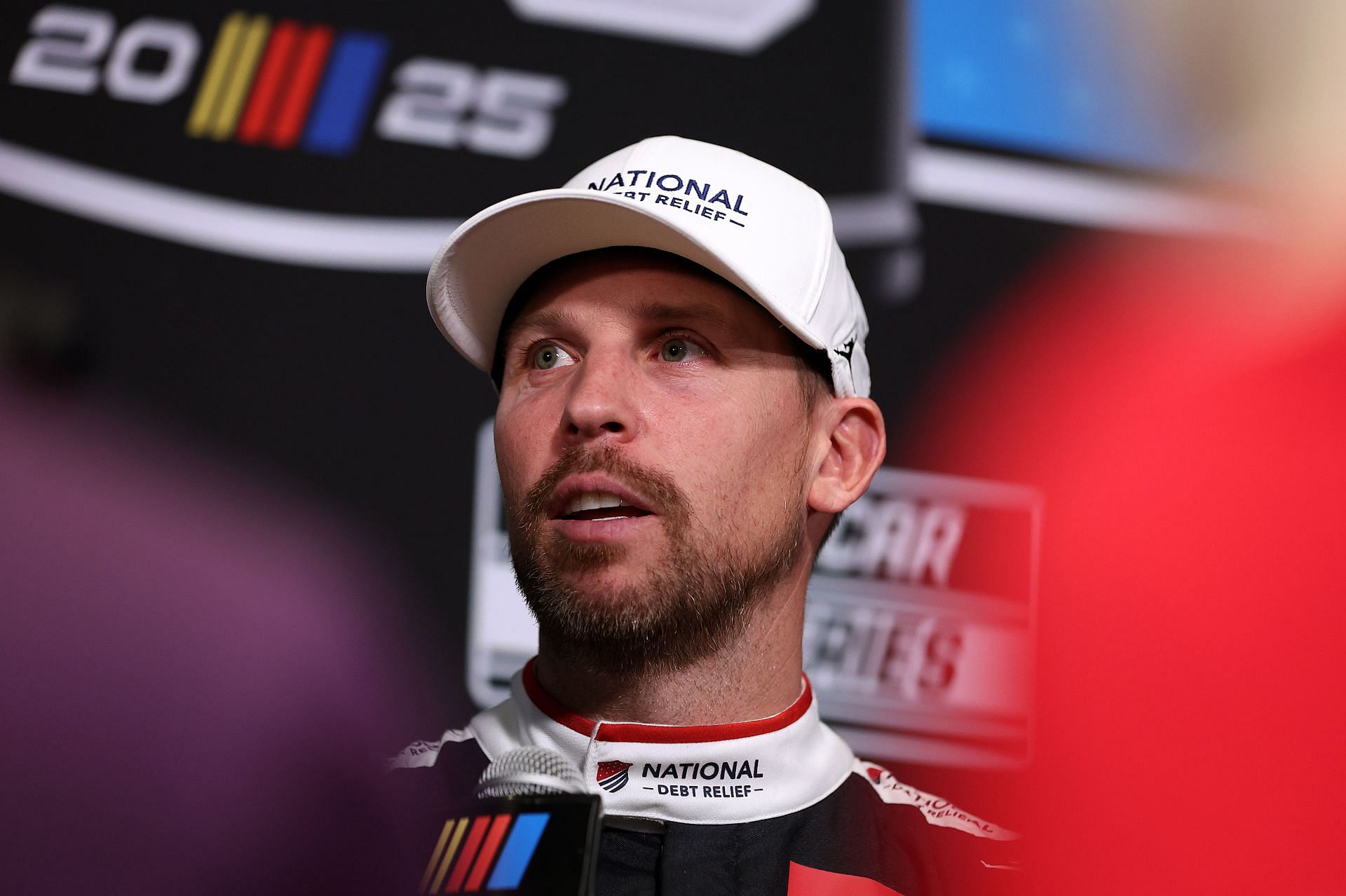 Denny Hamlin speaks to the media during Media Day for the 2025 Daytona 500 - Source: Getty