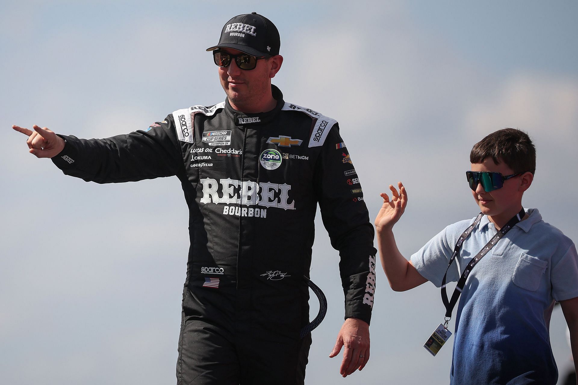  Kyle Busch and his son Brexton wave to fans as they walk onstage during driver intros prior to the 2025 EchoPark Automotive Grand Prix (Source: Getty)