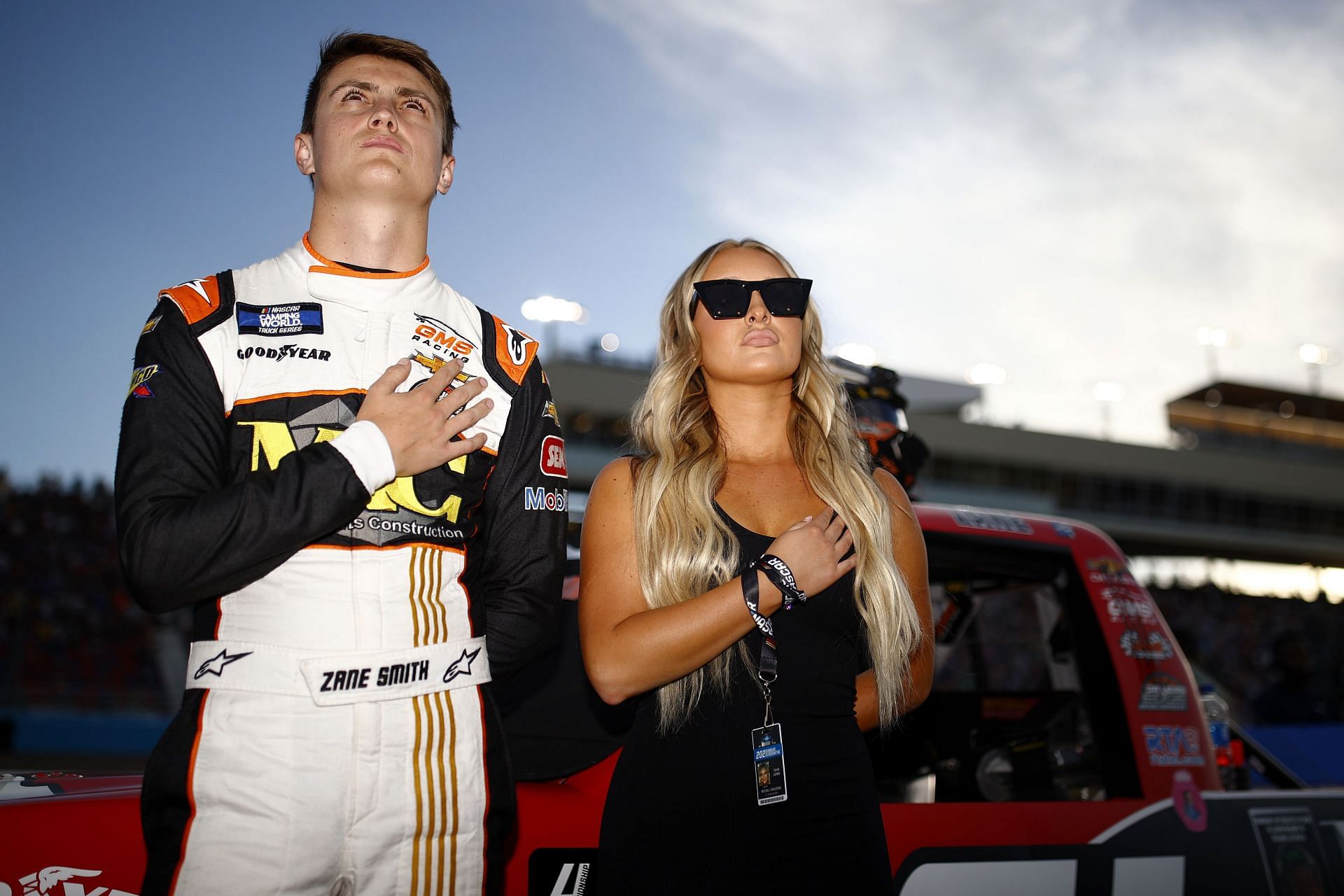 Zane Smith and his wife McCall during the national anthem  on the grid prior to the  2021 NASCAR Camping World Truck Series Lucas Oil 150 2021 (Source: Getty)