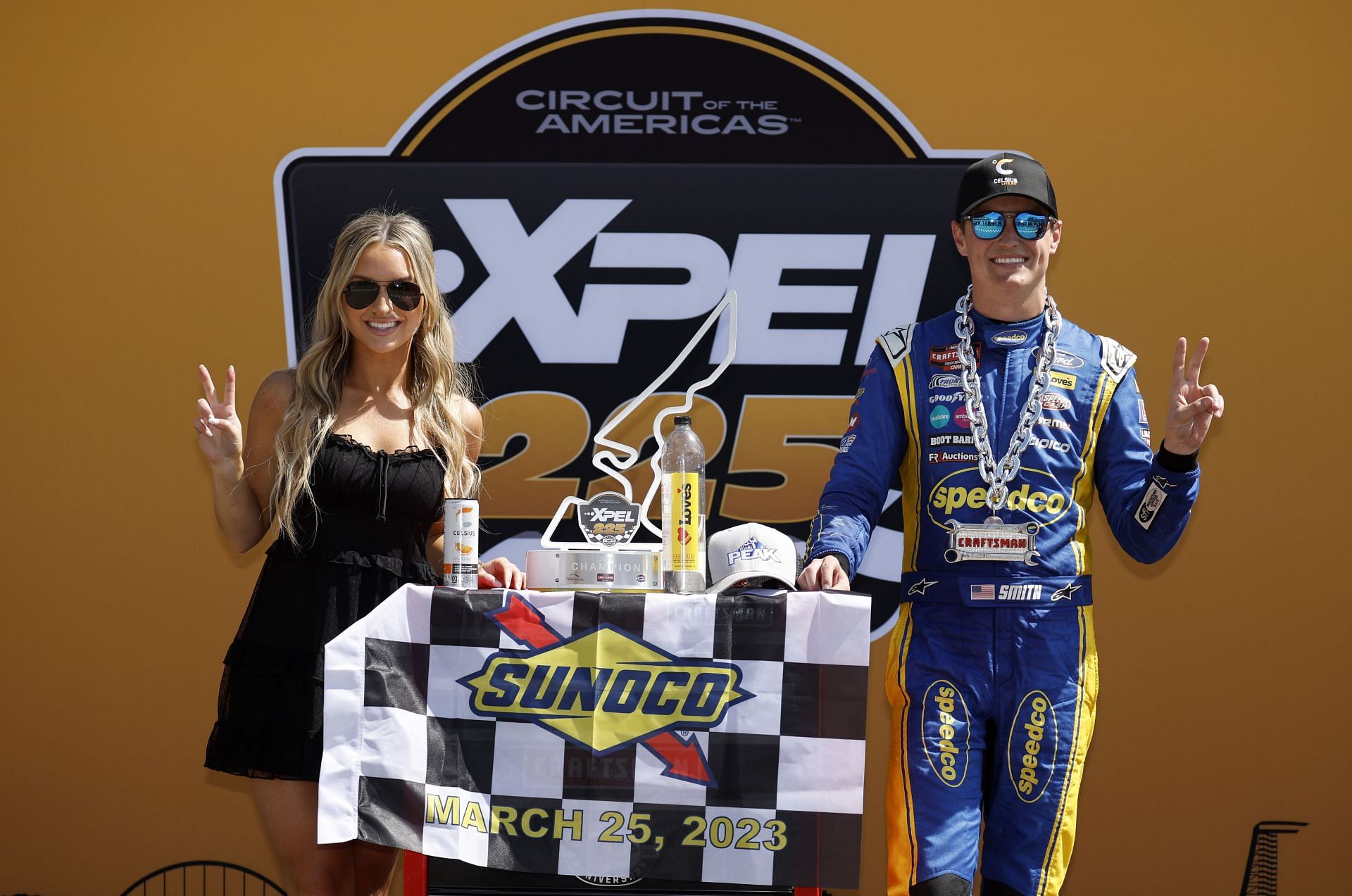 Zane Smith poses with wife McCall in victory lane after winning the 2023 NASCAR Craftsman Truck Series XPEL 225 at COTA (Source: Getty)