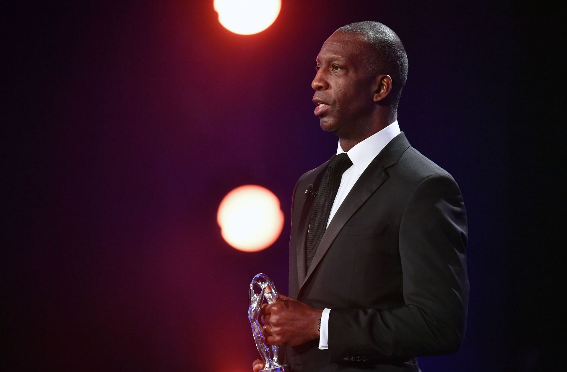 Michael Johnson speaking on the stage wearing a black blazer during the 2018 Laures World Sports Awards in Monaco (Image via: Getty Images)