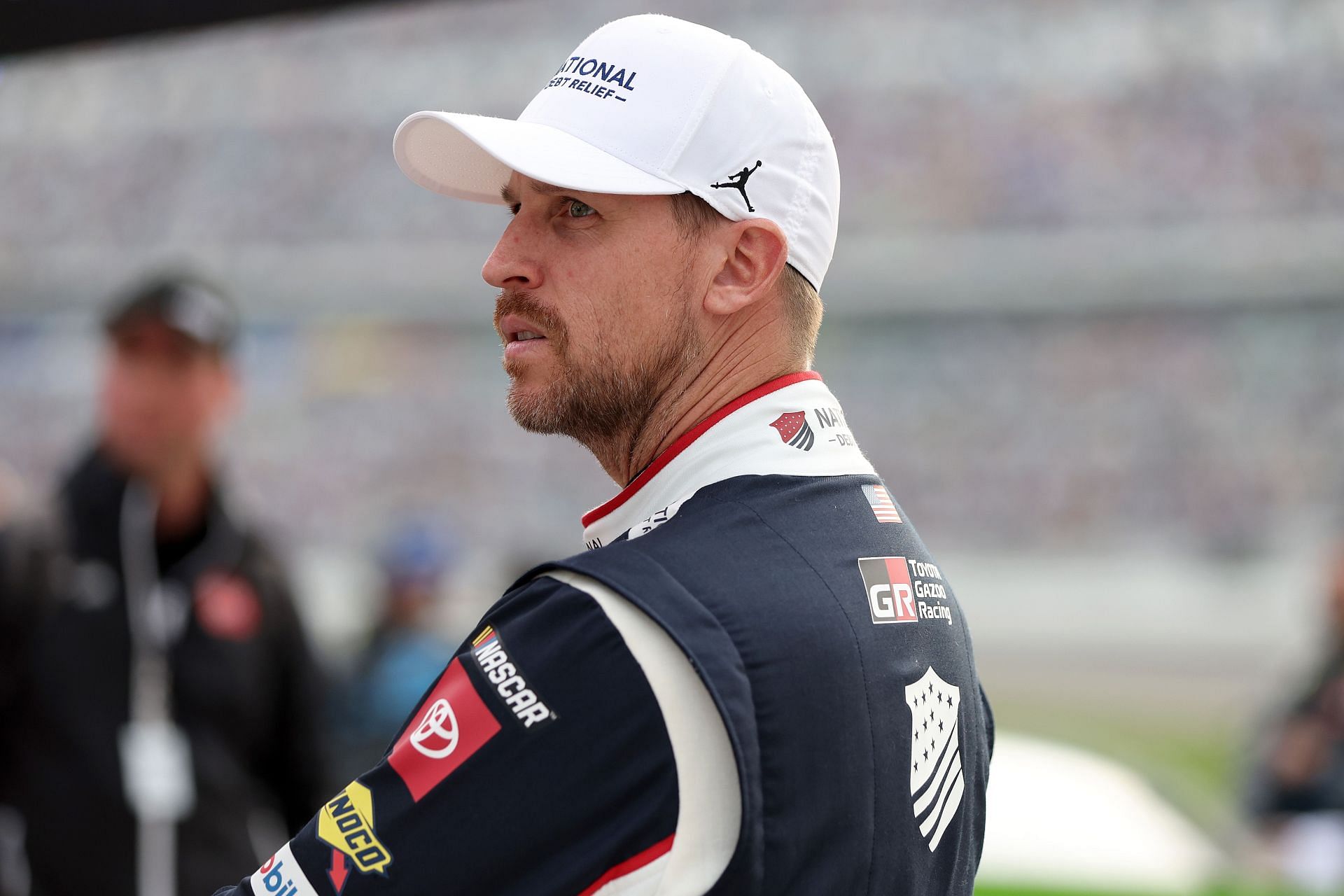 Denny Hamlin waits on the grid after a weather delay in the 2025 Daytona 500 (Source: Getty)