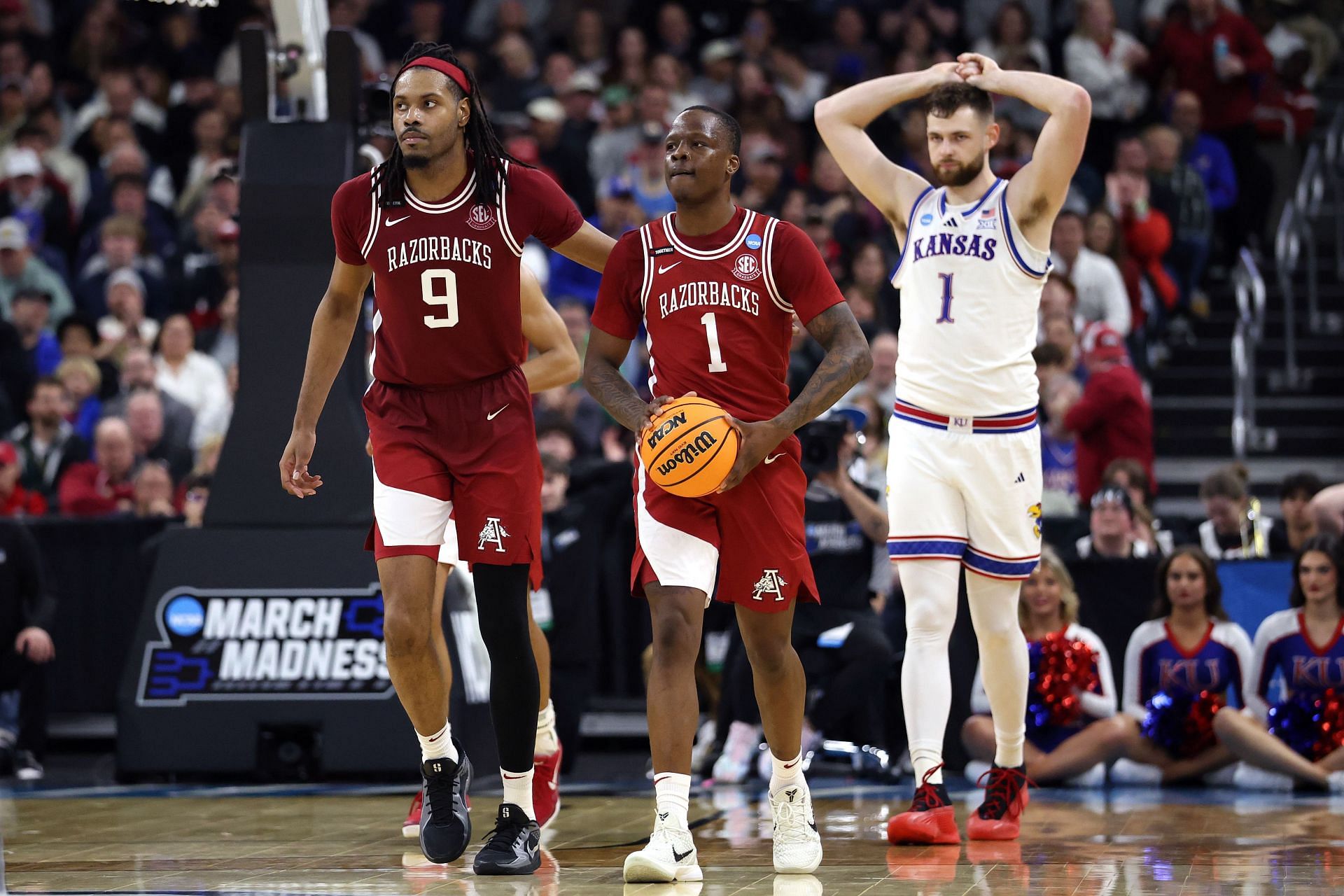 Johnell Davis (#1) and Jonas Aidoo (#9) of the Arkansas Razorbacks look on ahead of Hunter Dickinson (#1) of the Kansas Jayhawks in the first round of the NCAA Men&#039;s Basketball Tournament at Amica Mutual Pavillion on March 20, 2025. Photo: Getty