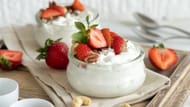 Greek yogurt with fresh berries makes for a dessert-like high protein snack (Image via Canva)