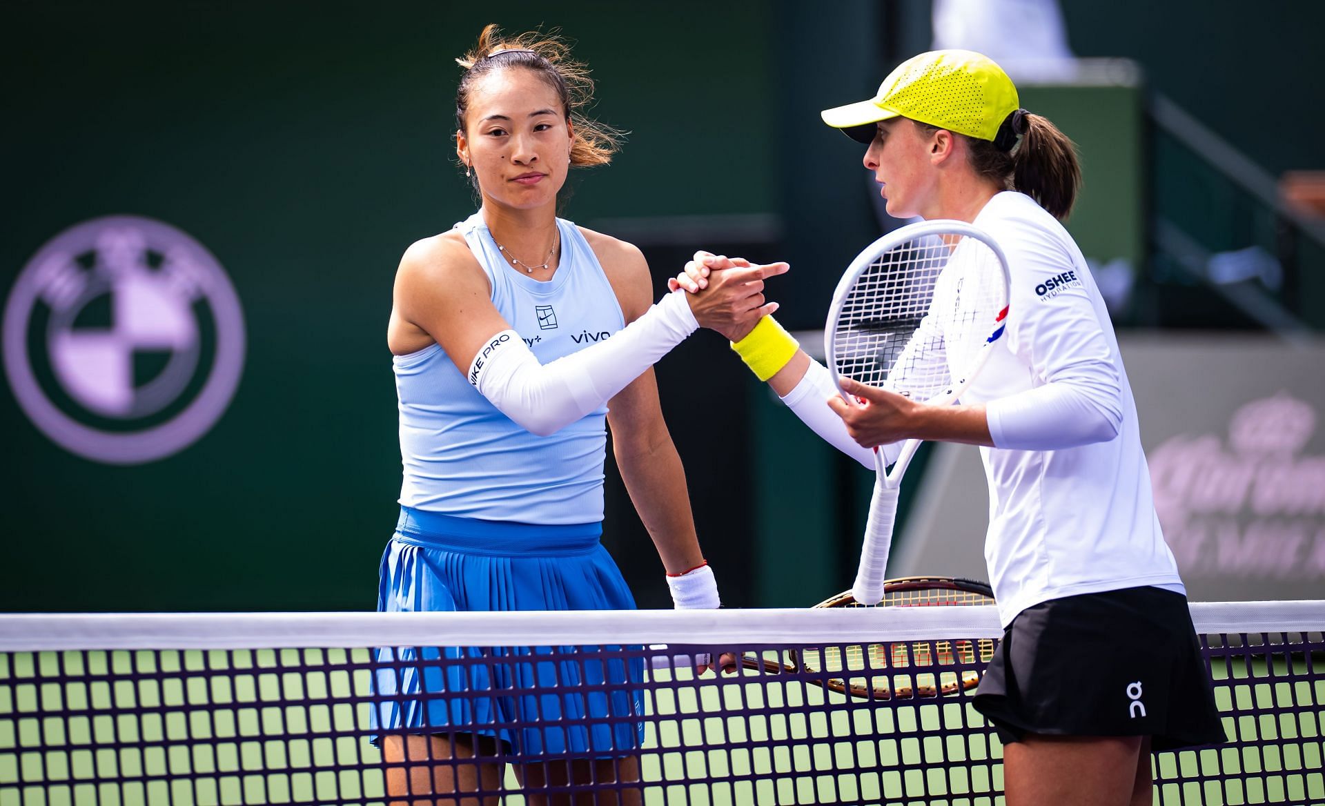 Zheng Qinwen of China and Iga Swiatek of Poland shake hands at the net after the quarter-final on Day 9 of the BNP Paribas Open - Source: Getty