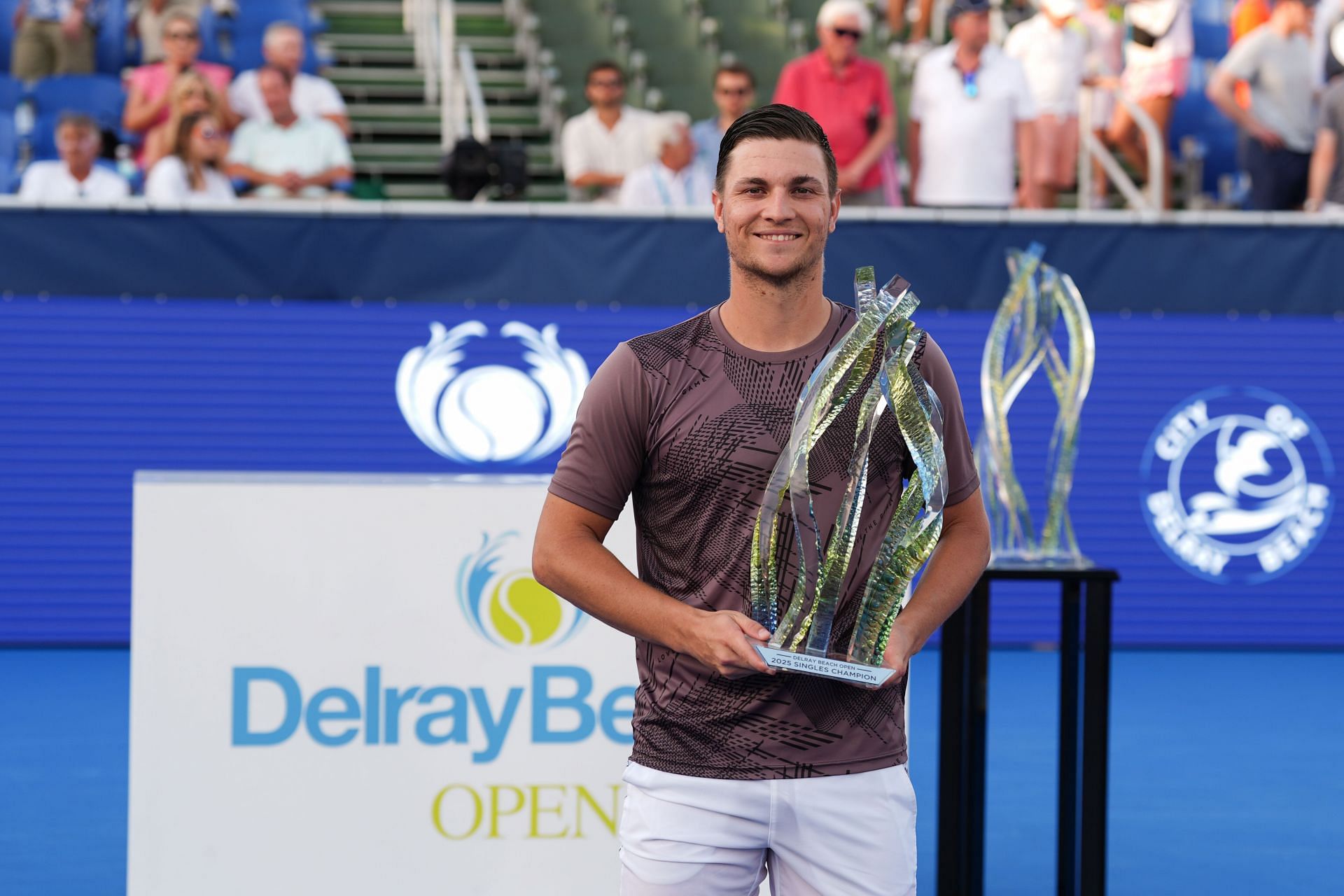 Miomir Kecmanovic (SRB) celebrates with the trophy after winning the Delray Beach Open - Source: Getty