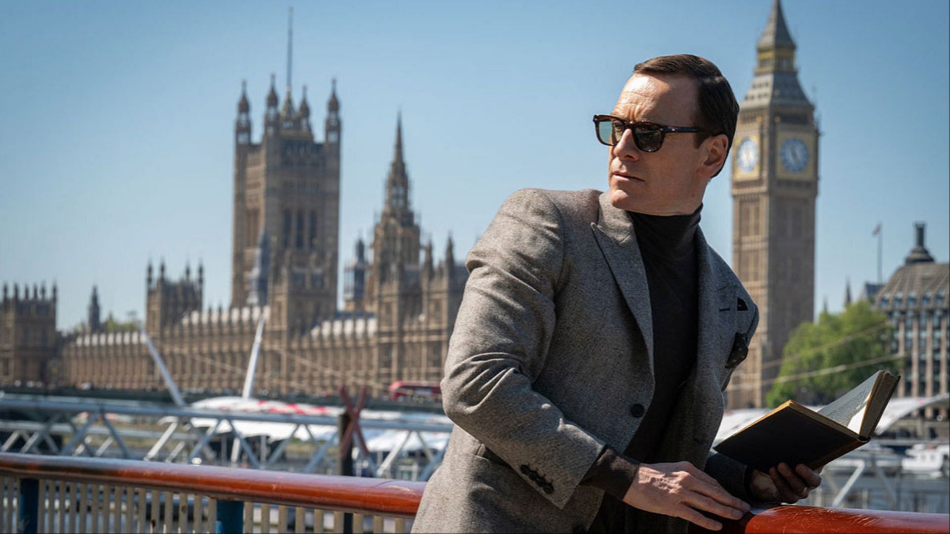 Michael Fassbender as George Woodhouse in Black Bag, set against the London skyline. (Image via Focus Features)