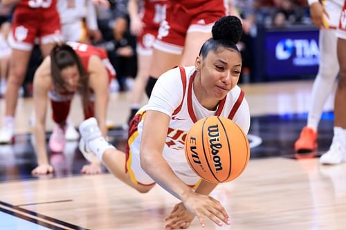 JuJu Watkins (#12) of the USC Trojans dives for the ball in the first half against the Indiana Hoosiers during the quarterfinal round of the Big Ten Tournament at Gainbridge Fieldhouse. Photo: Getty