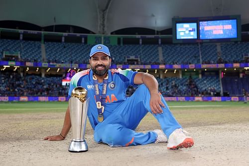 The Indian captain poses with the Champions Trophy. Source: Getty