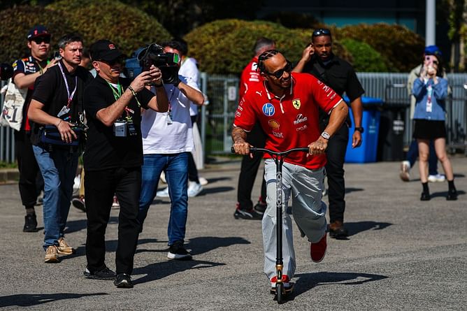 WATCH: Lewis Hamilton enters the Mercedes garage on his scooter wearing his Ferrari Red overalls