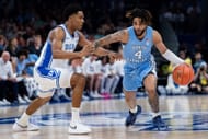 RJ Davis (#4) of the North Carolina Tar Heels attacks the defense of Caleb Foster (#1) of the Duke Blue Devils in the first half of their ACC Tournament semifinal at Spectrum Center. Photo: Getty