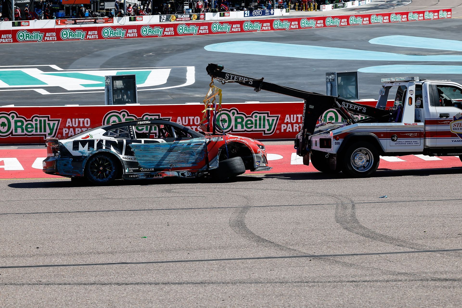 The car of Carson Hocevar (#77 Spire Motorsports Miner Docks Doors and more Chevrolet) is towed away after a crash during the NASCAR Cup Series Shriners Children&#039;s 500 on March 9, 2025 at Phoenix Raceway in Avondale, Arizona. - Source: Getty