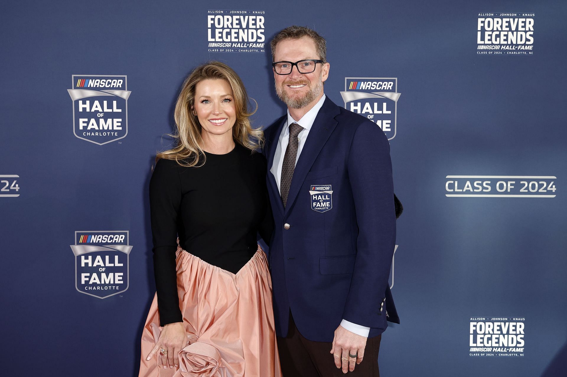 Dale Earnhardt Jr. and his wife, Amy Earnhardt pose for photos on the red carpet prior to the 2024 NASCAR Hall of Fame Induction Ceremony. (Source: Getty)