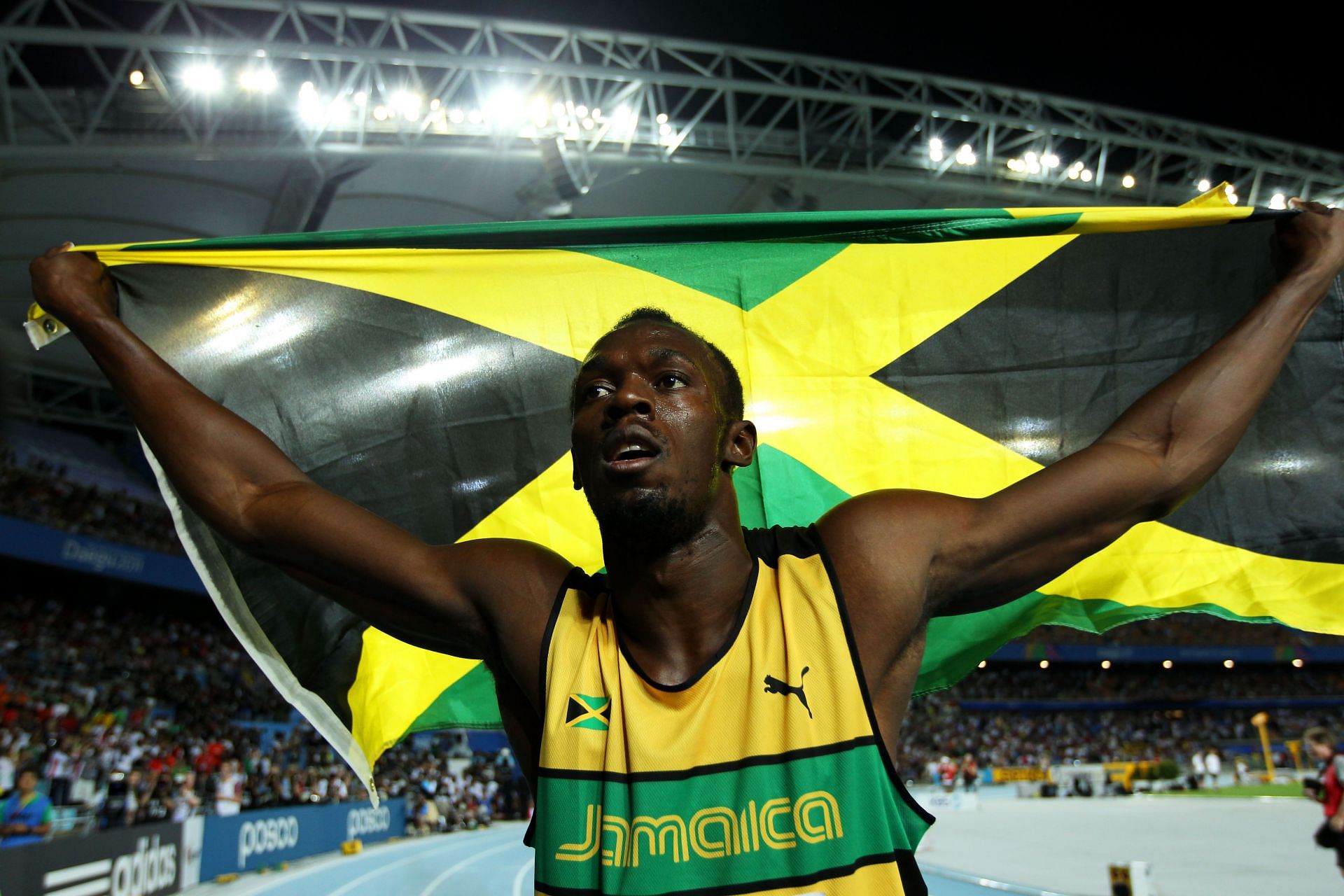 Usain Bolt celebrates after winning at the 13th IAAF World Athletics Championships Daegu 2011 - Day Eight - Source: Getty