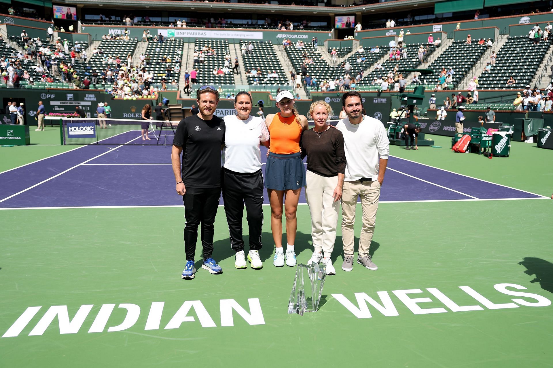 Mirra Andreeva pictured with Conchita Martinez (second from left), her mother (second from right), and team at the 2025 BNP Paribas Open in Indian Wells - Image Source: Getty