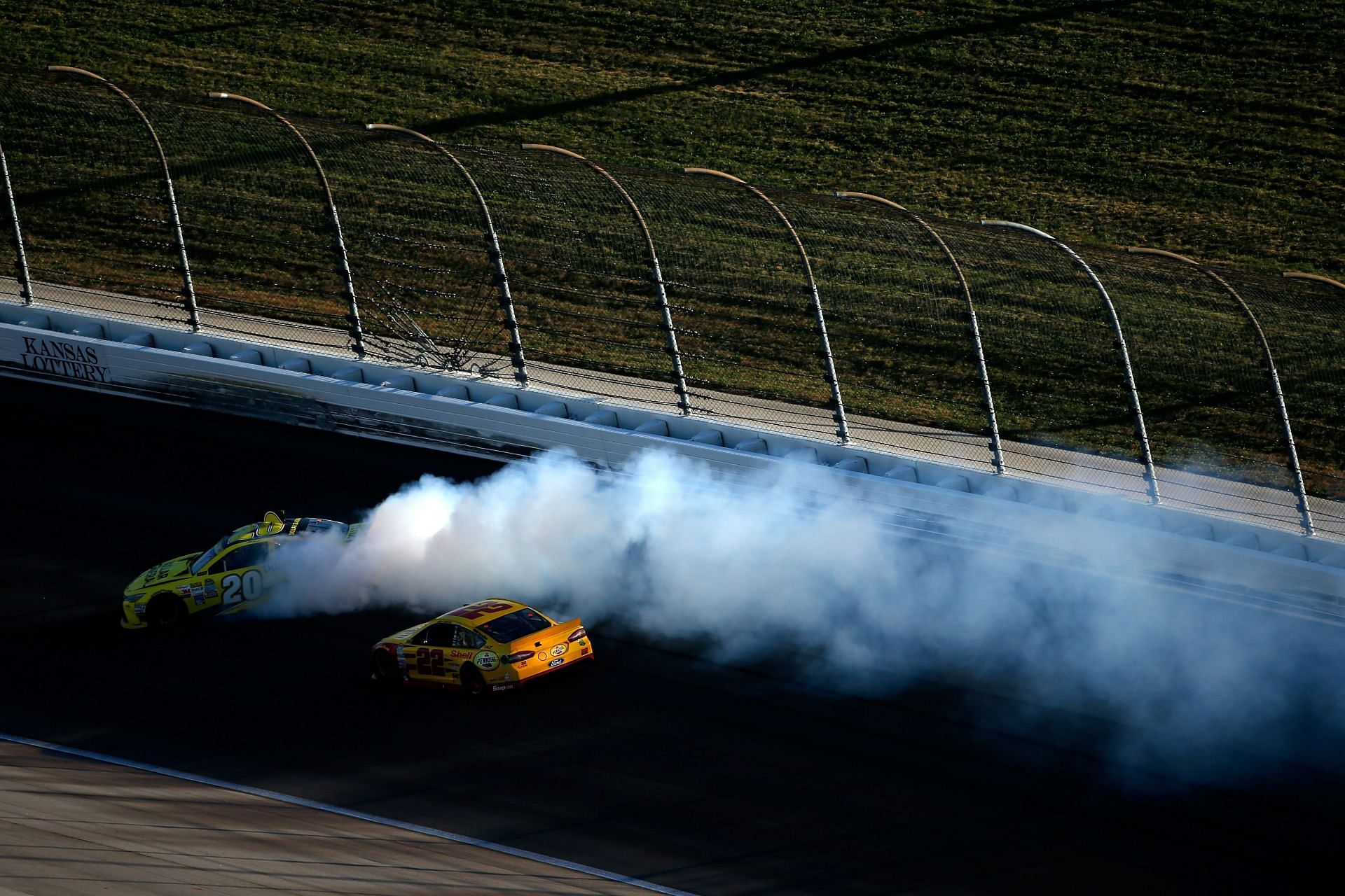 Matt Kenseth, #20 Dollar General Toyota, spins as Joey Logano, the #22 Shell Pennzoil Ford, races by in Kansas on October 18, 2015 - Source: Getty