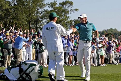 Rory McIlroy celebrates with caddie during 2022 Masters Tournament - Final Round - Source: Imagn