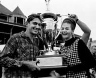 Bobby Allison, left, receives the trophy and $1,000 check for winning the Southern 300 at the Fairgrounds Speedway on Oct. 4, 1964. Source: Imagn
