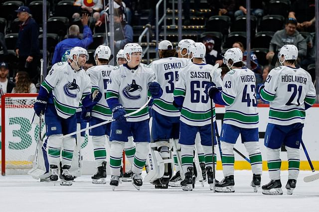 Apr 10, 2025; Denver, Colorado, USA; Vancouver Canucks left wing Jake DeBrusk (74) and center Aatu Raty (54) celebrate with teammates after the game against the Colorado Avalanche at Ball Arena. Mandatory Credit: Isaiah J. Downing-Imagn Images - Source: Imagn